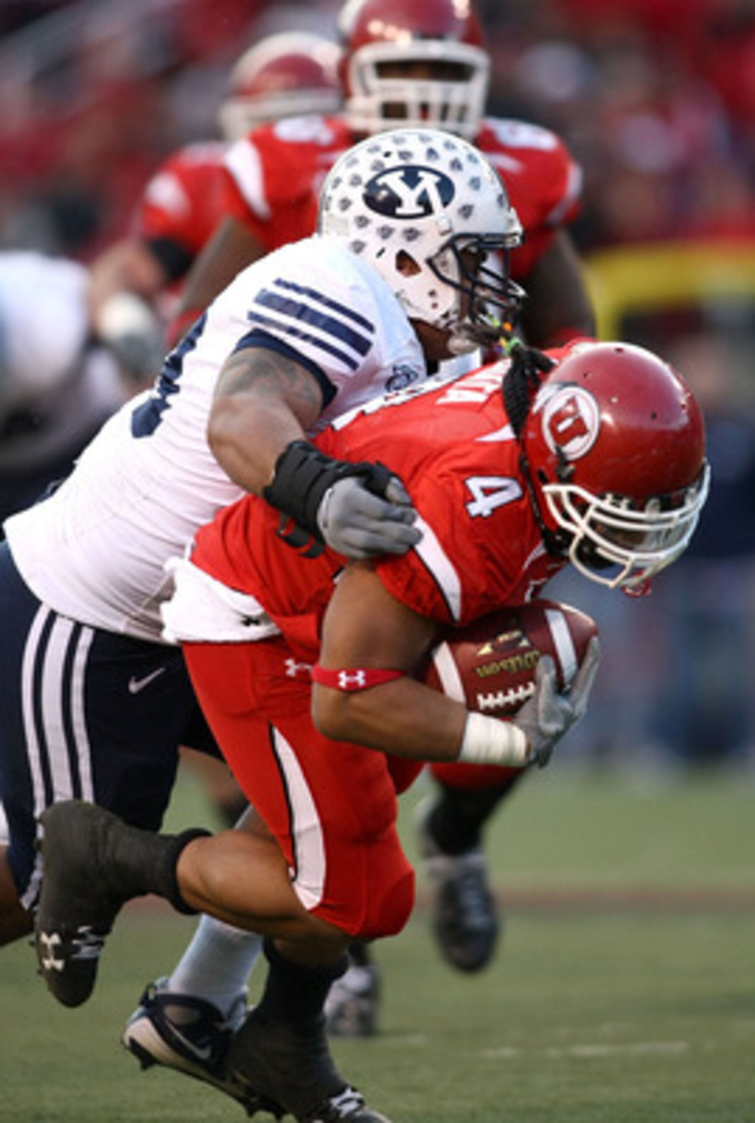 SALT LAKE CITY - NOVEMBER 22:  Matt Asiata #4 of the Utah Utes runs with the ball against the BYU Cougars at Rice-Eccles Stadium on November 22, 2008 in Salt Lake City, Utah.  (Photo by Jonathan Ferrey/Getty Images)