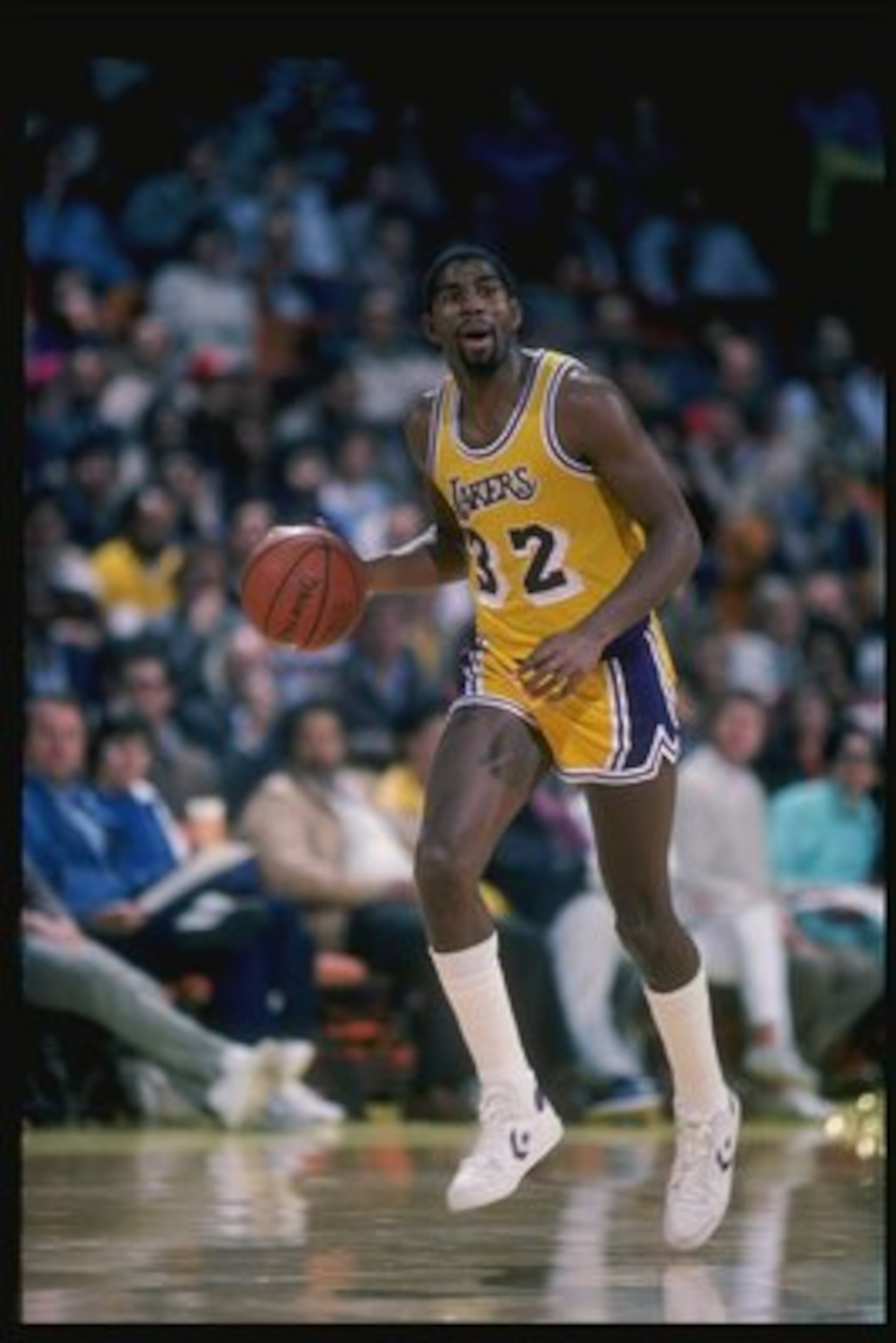 Guard Magic Johnson of the Los Angeles Lakers driibbles the ball down the court during a game at the Great Western Forum in Inglewood, California. Guard Magic Johnson of the Los Angeles Lakers driibbles the ball down the court during a game at the Great Western Forum in Inglewood, California.
