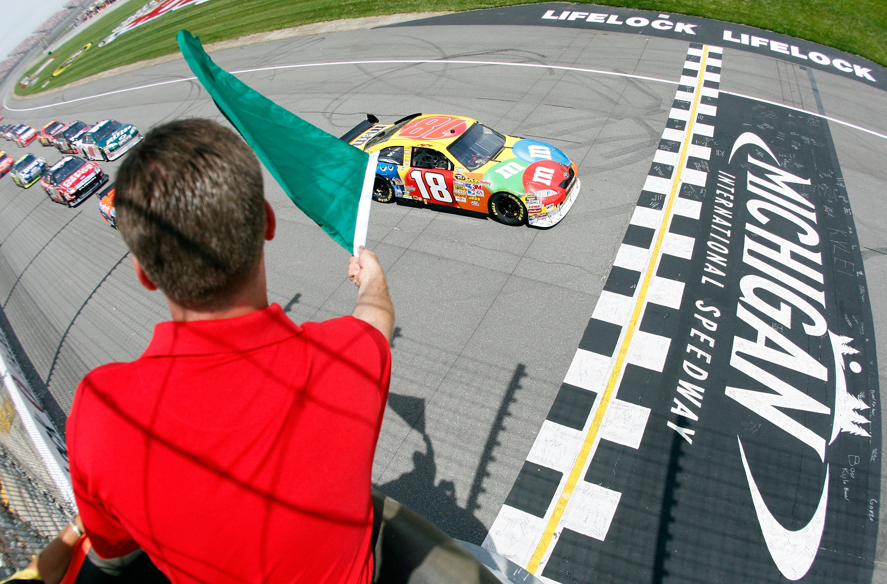 BROOKLYN, MI - JUNE 15:  Kyle Busch, driver of the #18 M&M's Toyota, crosses the start line at the green flag during the NASCAR Sprint Cup Series Lifelock 400 at the Michigan International Speedway on June 15, 2008 in Brooklyn, Michigan.  (Photo by Chris