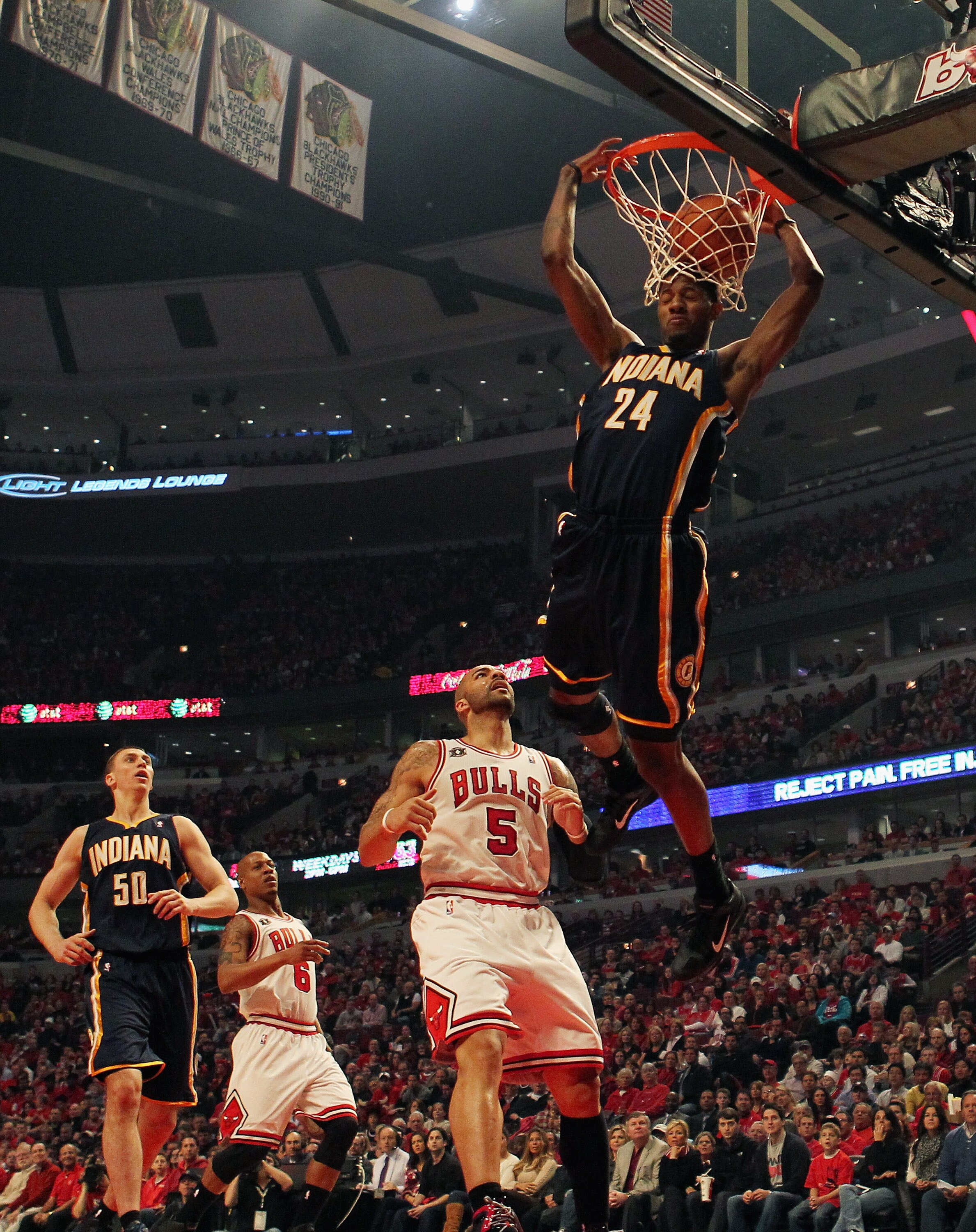 CHICAGO, IL - APRIL 16: Paul George #24 of the Indiana Pacers dunks the ball over Carlos Boozer #5 of the Chicago Bulls in Game One of the Eastern Conference Quarterfinals in the 2011 NBA Playoffs at the United Center on April 16, 2011 in Chicago, Illinoi