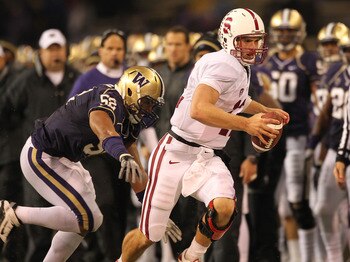 SEATTLE - OCTOBER 30:  Quarterback Andrew Luck #12 of the Stanford Cardinal rushes against Hau'oli Jamora #52 of the Washington Huskies on October 30, 2010 at Husky Stadium in Seattle, Washington. Stanford defeated Washington 41-0. (Photo by Otto Greule J
