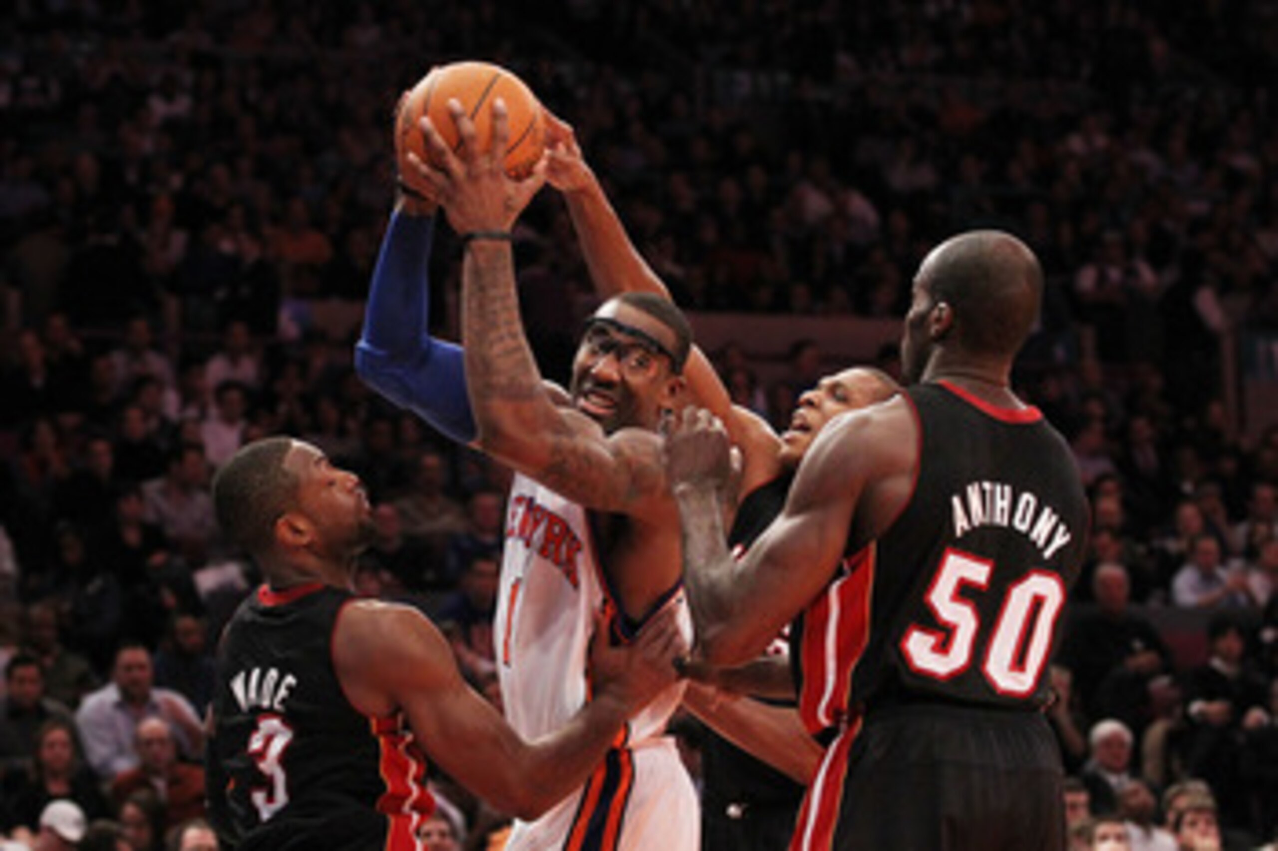 NEW YORK, NY - DECEMBER 17:  Amar'e Stoudemire #1 of the New York Knicks is surrounded by Dwyane Wade #3 and Joel Anthony #50 of the Miami Heat at Madison Square Garden on December 17, 2010 in New York City. NOTE TO USER: User expressly acknowledges and a