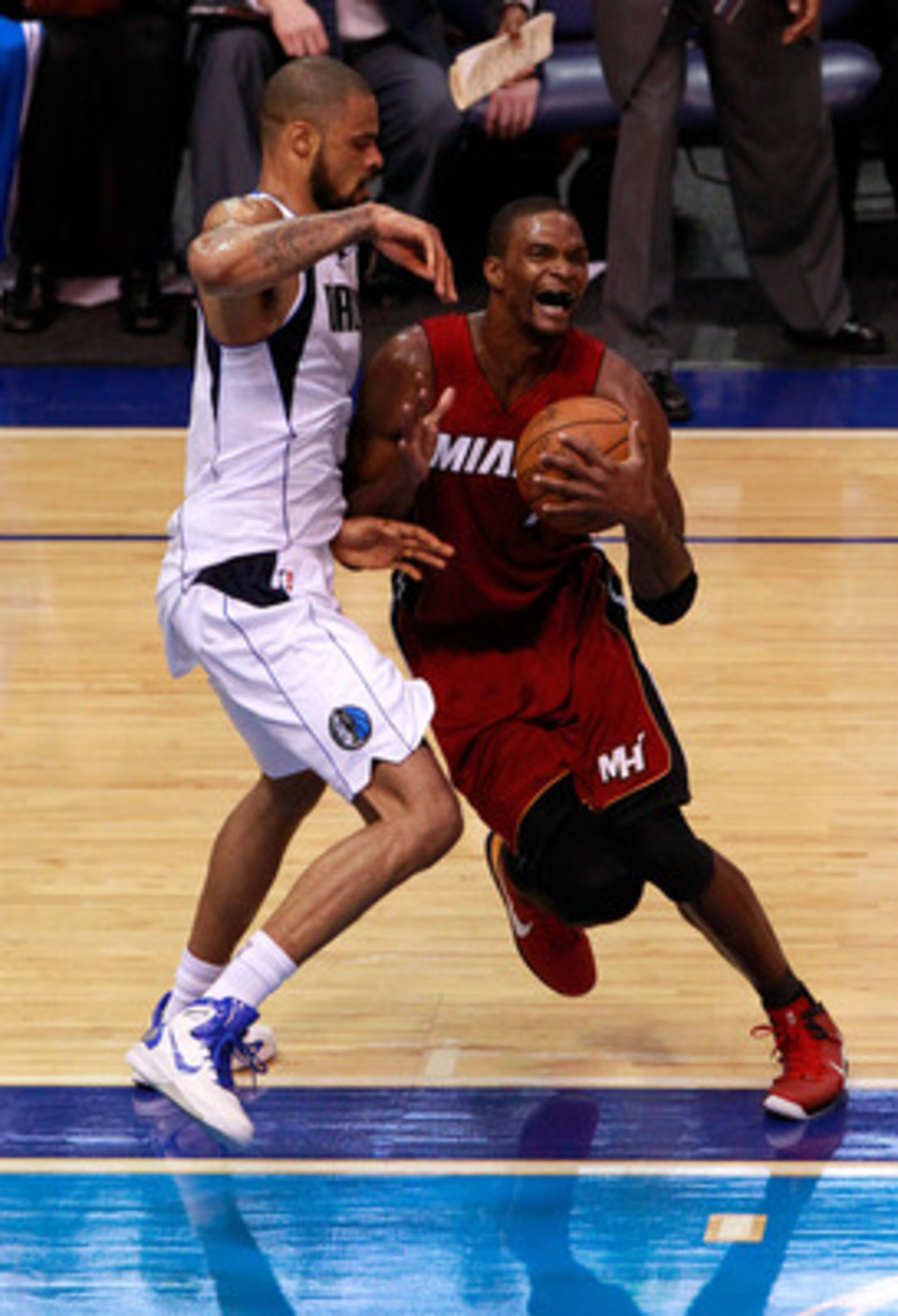 DALLAS, TX - JUNE 07:  Chris Bosh #1 of the Miami Heat drives against Tyson Chandler #6 of the Dallas Mavericks in Game Four of the 2011 NBA Finals at American Airlines Center on June 7, 2011 in Dallas, Texas. The Mavericks won 86-83. NOTE TO USER: User e