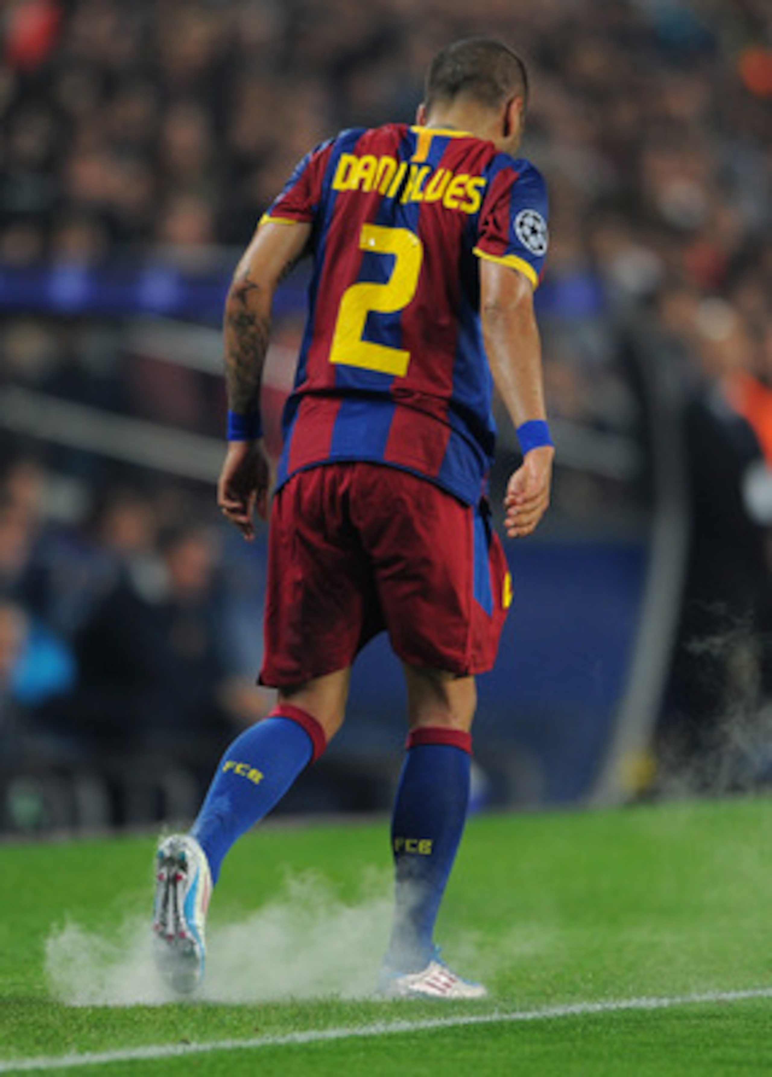 BARCELONA, SPAIN - APRIL 06:  Daniel Alves of Barcelona walks off after getting his ankle sprayed during the UEFA Champions League quarter final first leg match between Barcelona and Shakhtar Donetsk at the Camp Nou stadium on April 6, 2011 in Barcelona, 