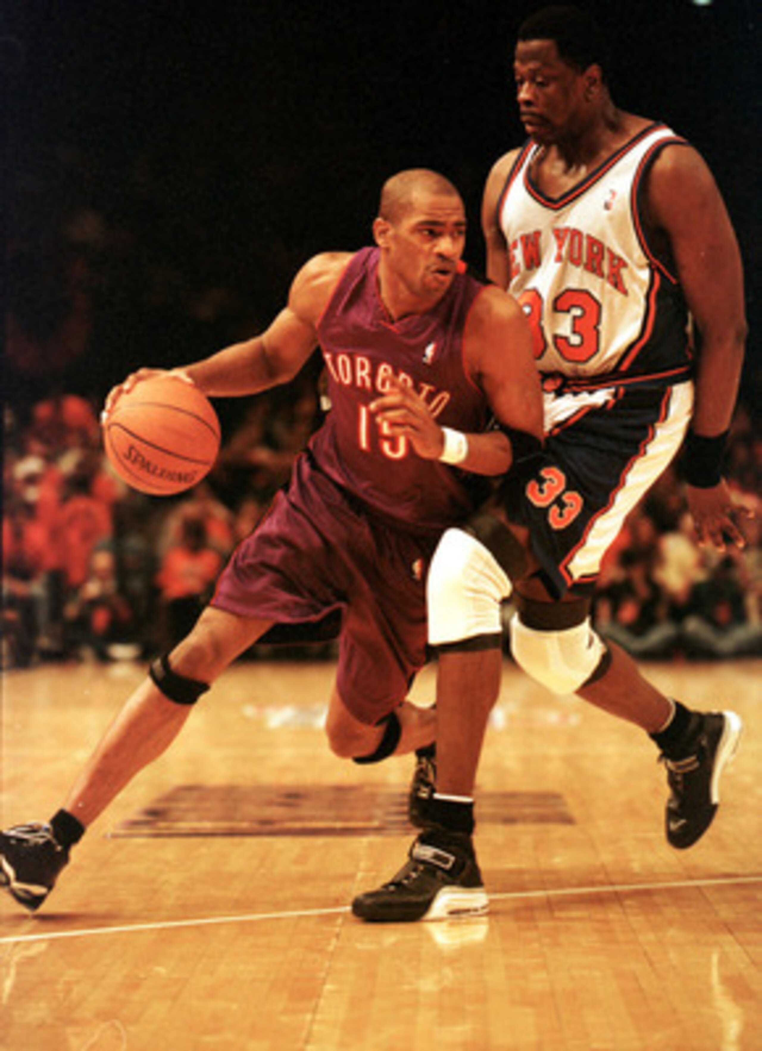 23 Apr 2000: Vince Carter #15 of the Toronto Raptors drives past Patrick Ewing #33 of the New York Knicks during their game at Madison Square Garden in New York City. The Knicks won game one of the first round playoff matchup 92-88.