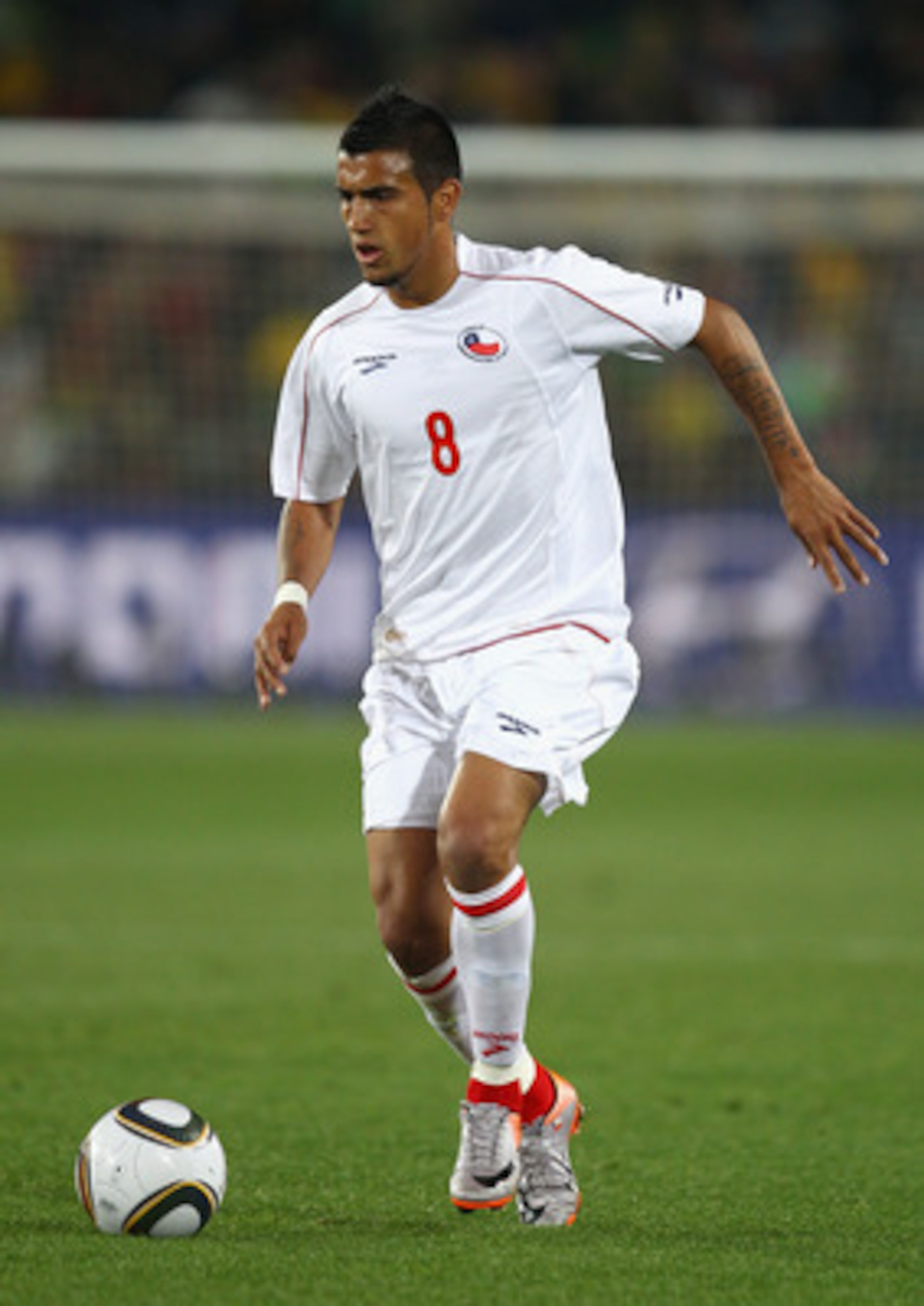 JOHANNESBURG, SOUTH AFRICA - JUNE 28:  Arturo Vidal of Chile runs with the ball during the 2010 FIFA World Cup South Africa Round of Sixteen match between Brazil and Chile at Ellis Park Stadium on June 28, 2010 in Johannesburg, South Africa.  (Photo by Ri