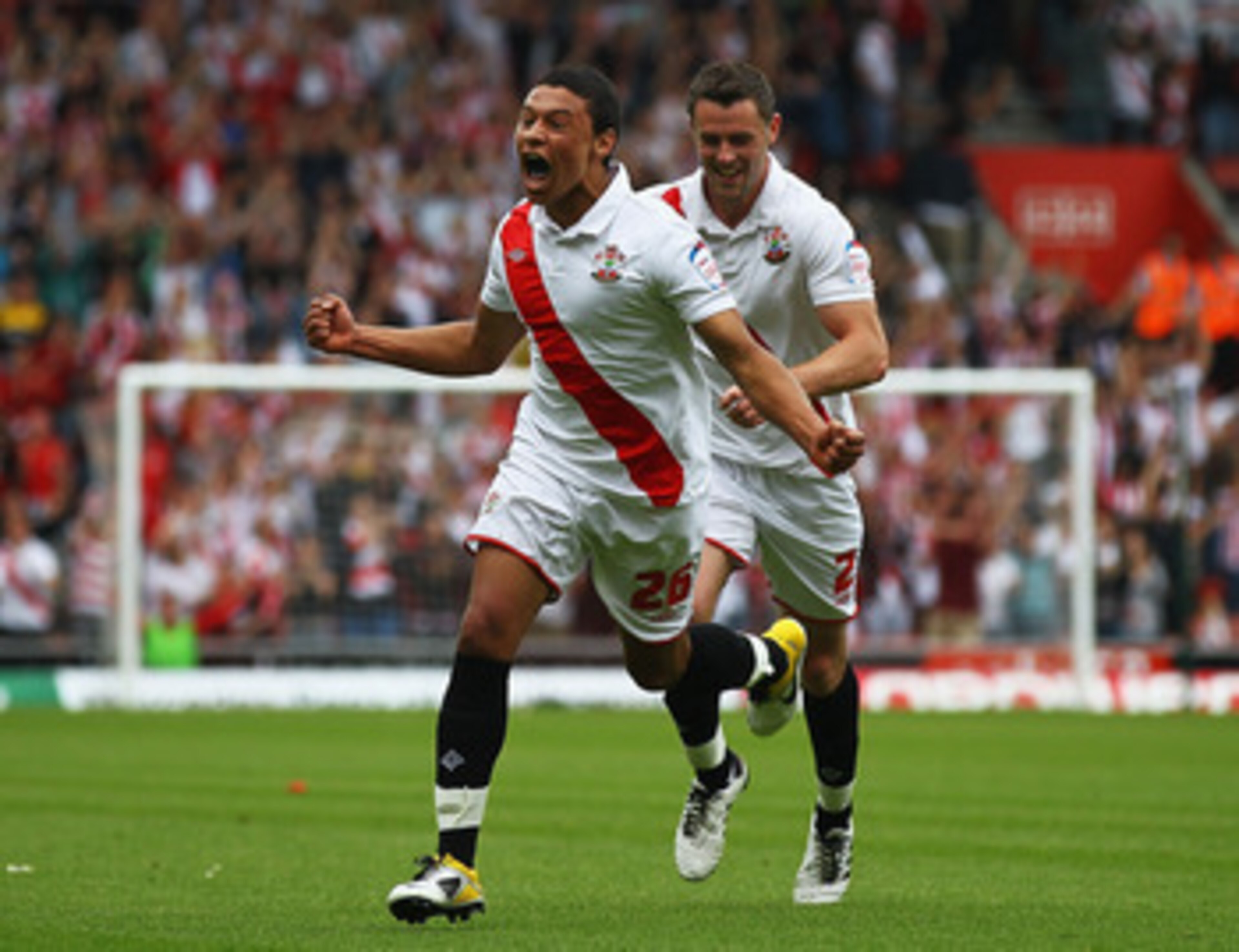 SOUTHAMPTON, ENGLAND - MAY 07:  Alex Chamberlain (L) of Southampton celebrates his goal with team mate Frazer Richardson during the npower League One match between Southampton and Walsall at St Mary's Stadium on May 7, 2011 in Southampton, England.  (Phot
