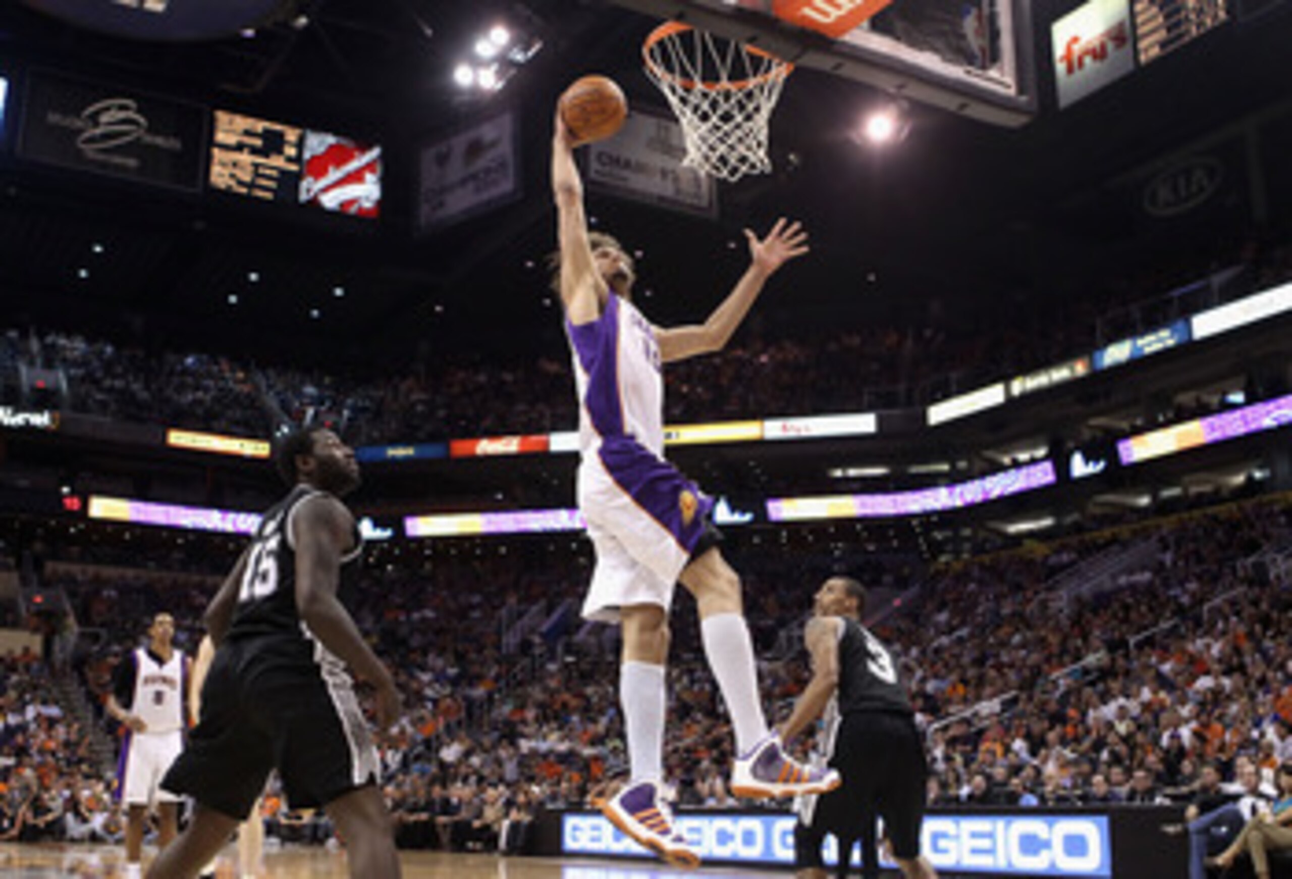 PHOENIX, AZ - APRIL 13:  Robin Lopez #15 of the Phoenix Suns slam dunks the ball against the San Antonio Spurs during the NBA game at US Airways Center on April 13, 2011 in Phoenix, Arizona.  NOTE TO USER: User expressly acknowledges and agrees that, by d