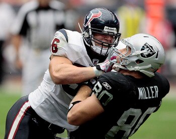 HOUSTON - OCTOBER 04:  Linebacker Brian Cushing #56 of the Houston Texans delivers a hard hit to tight-end Zach Miller #80 of the Oakland Raiders at Reliant Stadium on October 4, 2009 in Houston, Texas.  (Photo by Bob Levey/Getty Images)