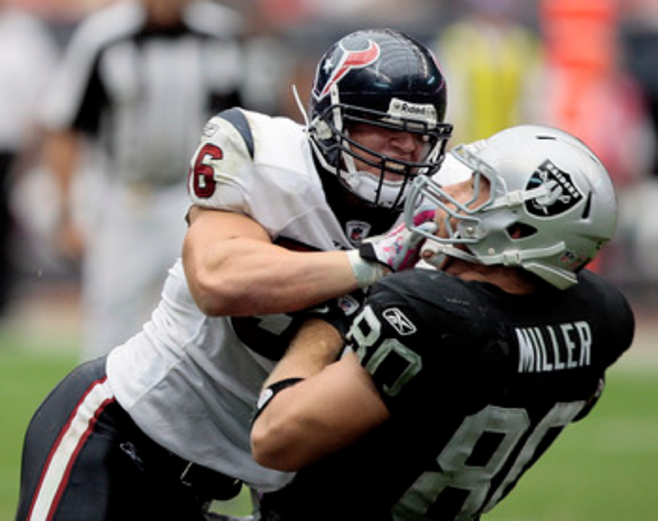 HOUSTON - OCTOBER 04:  Linebacker Brian Cushing #56 of the Houston Texans delivers a hard hit to tight-end Zach Miller #80 of the Oakland Raiders at Reliant Stadium on October 4, 2009 in Houston, Texas.  (Photo by Bob Levey/Getty Images)
