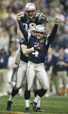 HOUSTON, TX - FEBRUARY 1:  Kicker Adam Vinatieri #4 of the New England Patriots celebrates with his teammates Christian Fauria #88 and Ken Walter #13 after kicking a 41-yard game-winning field goal in the forth quarter during Super Bowl XXXVIII against th