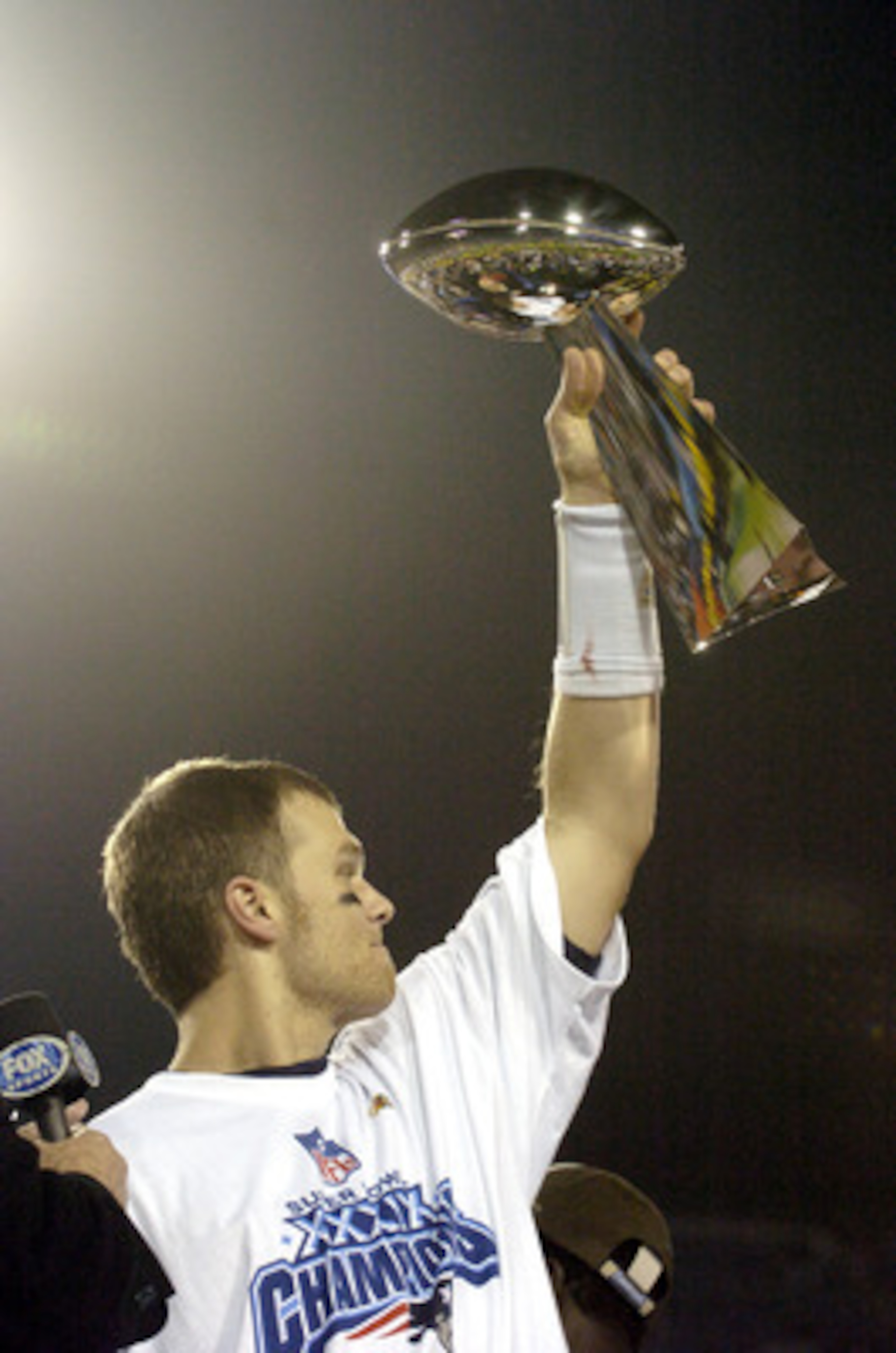 Tom Brady holds the Vince Lombardi Trophy as he stands on the podium after The New England Patriots defeated The Philadelphia Eagles in Super Bowl XXXIX at Alltel Staduim in Jacksonville, Florida. (Photo by Al Messerschmidt/Getty Images) Tom Brady holds the Vince Lombardi Trophy as he stands on the podium after The New England Patriots defeated The Philadelphia Eagles in Super Bowl XXXIX at Alltel Staduim in Jacksonville, Florida. (Photo by Al Messerschmidt/Getty Images)