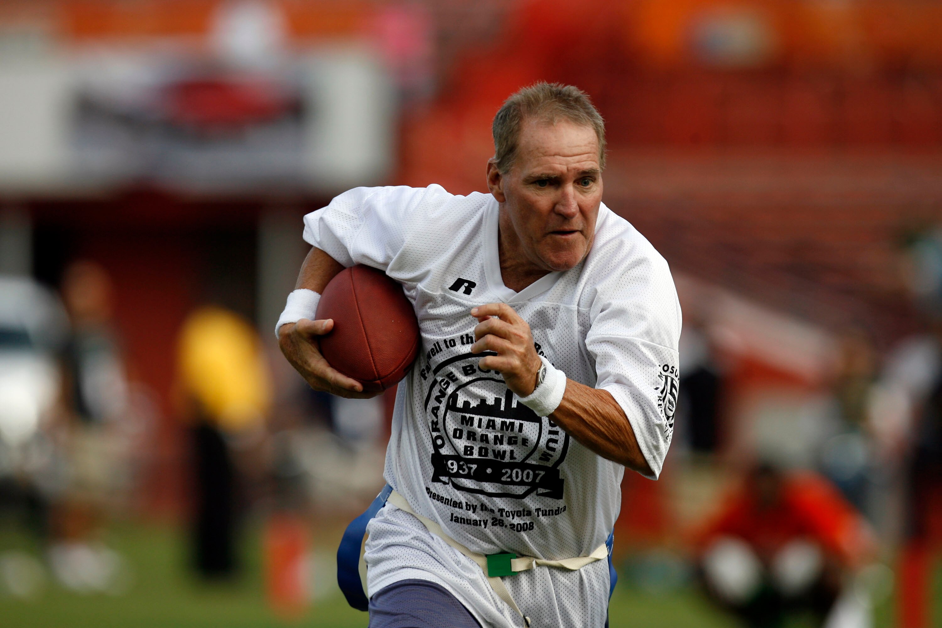 MIAMI, FL - JANUARY 26: Former Miami Dolphin Jim Kiick heads down field against the Miami Hurricanes at the Orange Bowl January 26, 2008 in Miami, Florida. This is the last game to be played in the Orange Bowl. (Photo by Eliot J. Schechter/Getty Images)