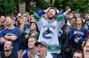 VANCOUVER, CANADA - JUNE 13: Vancouver Canucks fans react while gathered to watch Game Six of the 2011 NHL Stanley Cup Playoffs on June 13, 2011 at a viewing site in downtown Vancouver, British Columbia, Canada.  (Photo by Rich Lam/Getty Images)