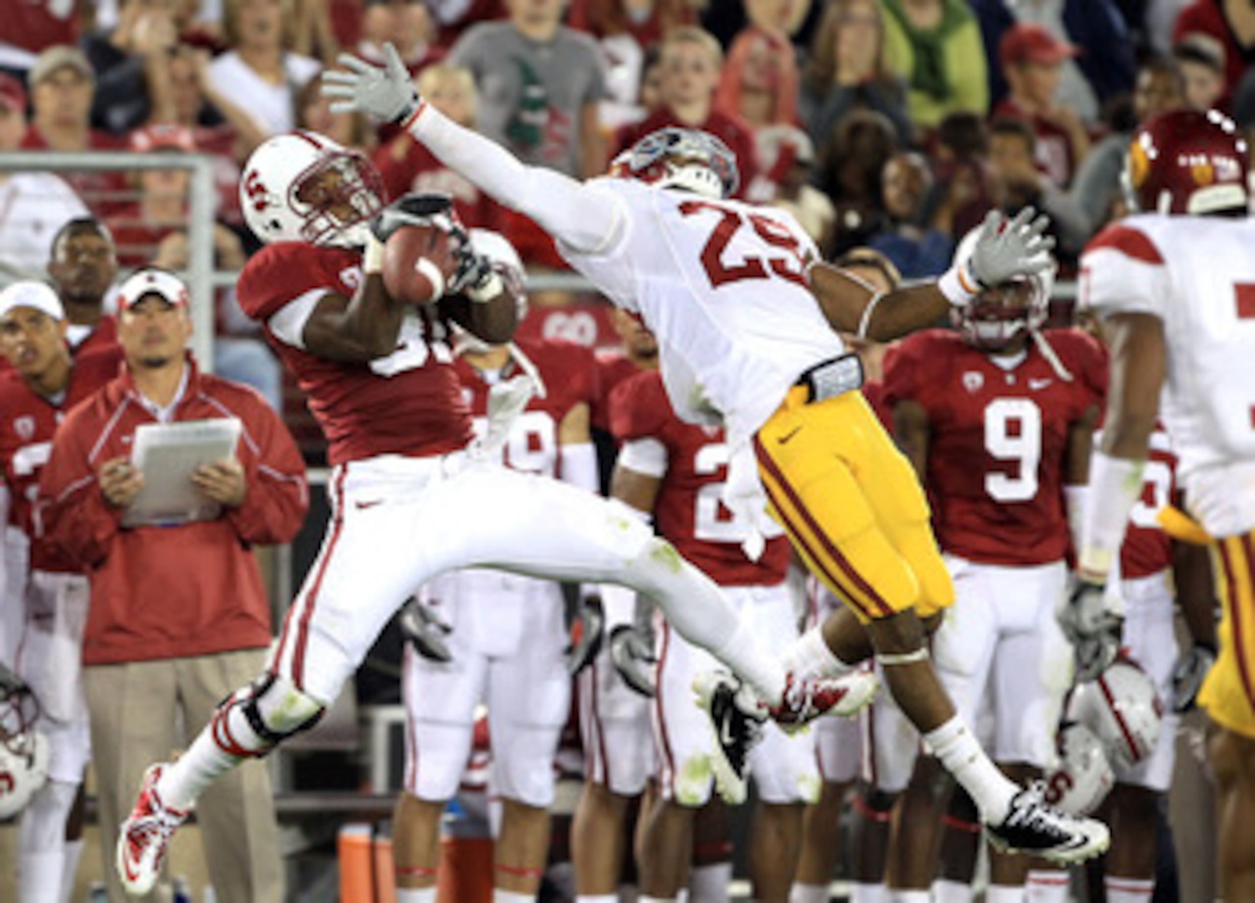 PALO ALTO, CA - OCTOBER 09:  Chris Owusu #81 of the Stanford Cardinal catches a ball over the outstreched arms of Jawanza Starling #29 of the USC Trojans at Stanford Stadium on October 9, 2010 in Palo Alto, California.  (Photo by Ezra Shaw/Getty Images)