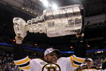 VANCOUVER, BC - JUNE 15:  Dennis Seidenberg #44 of the Boston Bruins celebrates with the Stanley Cup after defeating the Vancouver Canucks in Game Seven of the 2011 NHL Stanley Cup Final at Rogers Arena on June 15, 2011 in Vancouver, British Columbia, Can