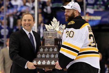 VANCOUVER, BC - JUNE 15:  NHL Commissioner Gary Bettman presents Tim Thomas #30 of the Boston Bruins with the Conn Smythe Trophy after defeating the Vancouver Canucks in Game Seven of the 2011 NHL Stanley Cup Final at Rogers Arena on June 15, 2011 in Vanc