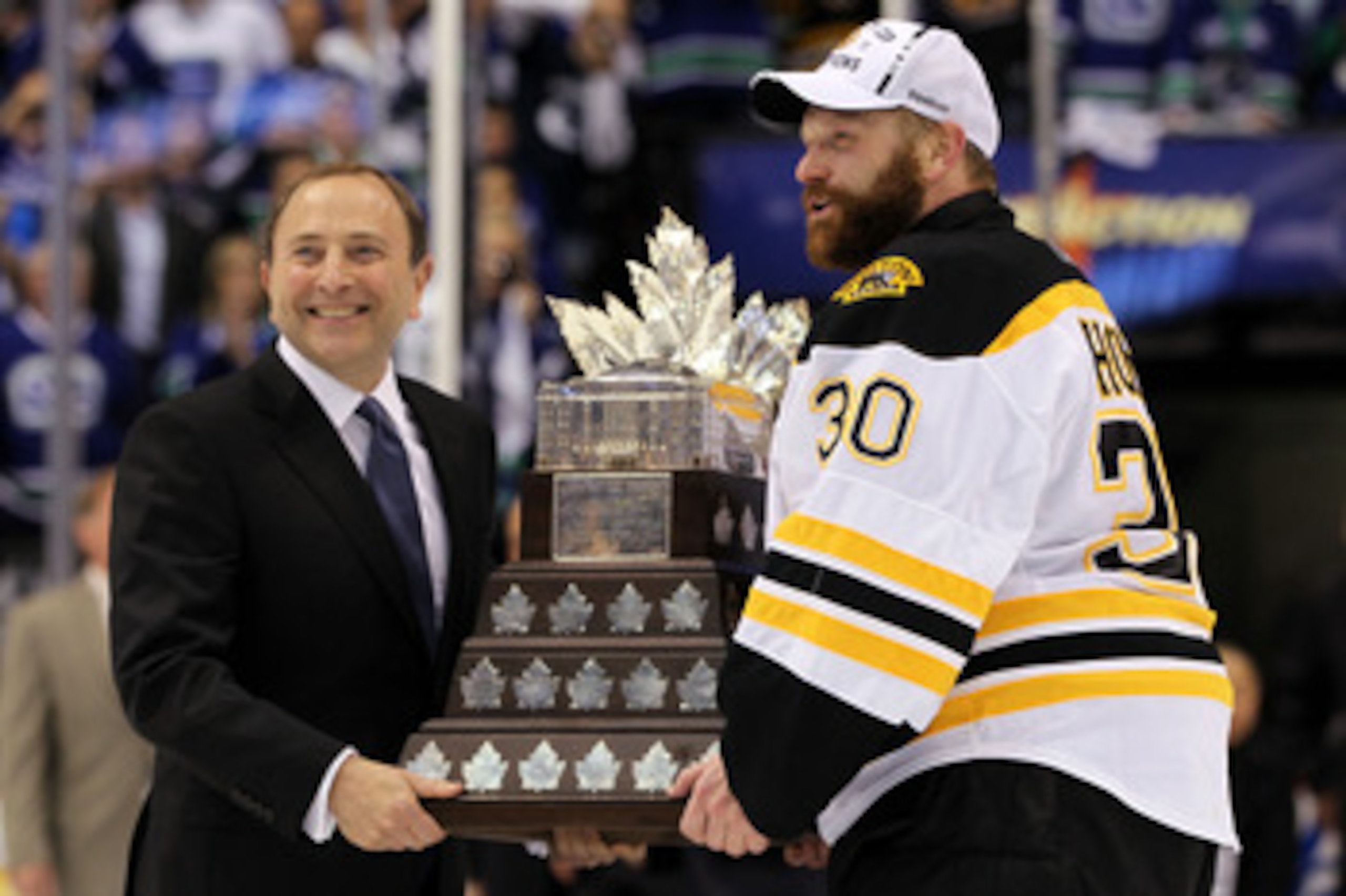 VANCOUVER, BC - JUNE 15:  NHL Commissioner Gary Bettman presents Tim Thomas #30 of the Boston Bruins with the Conn Smythe Trophy after defeating the Vancouver Canucks in Game Seven of the 2011 NHL Stanley Cup Final at Rogers Arena on June 15, 2011 in Vanc