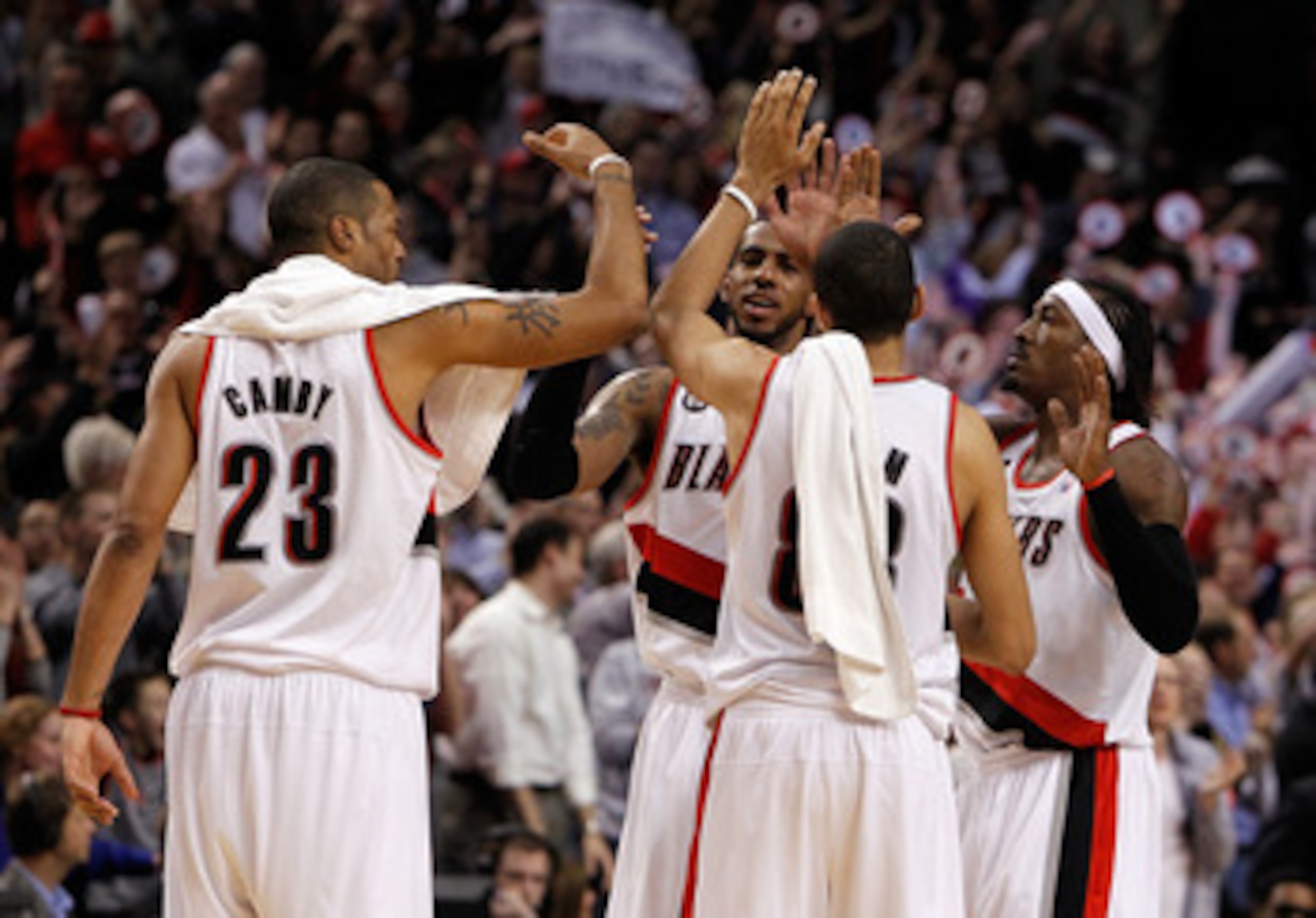 PORTLAND, OR - APRIL 21:  LaMarcus Aldridge #12, Gerald Wallace #3, Nicolas Batum #88 and Marcus Camby #23 of the Portland Trail Blazers celebrates their 97-92 victory over the Dallas Mavericks in Game Three of the Western Conference Quarterfinals in the 