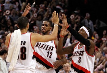 PORTLAND, OR - APRIL 21:  LaMarcus Aldridge #12, Gerald Wallace #3 and Nicolas Batum of the Portland Trail Blazers celebrates their 97-92 victory over the Dallas Mavericks in Game Three of the Western Conference Quarterfinals in the 2011 NBA Playoffs on A