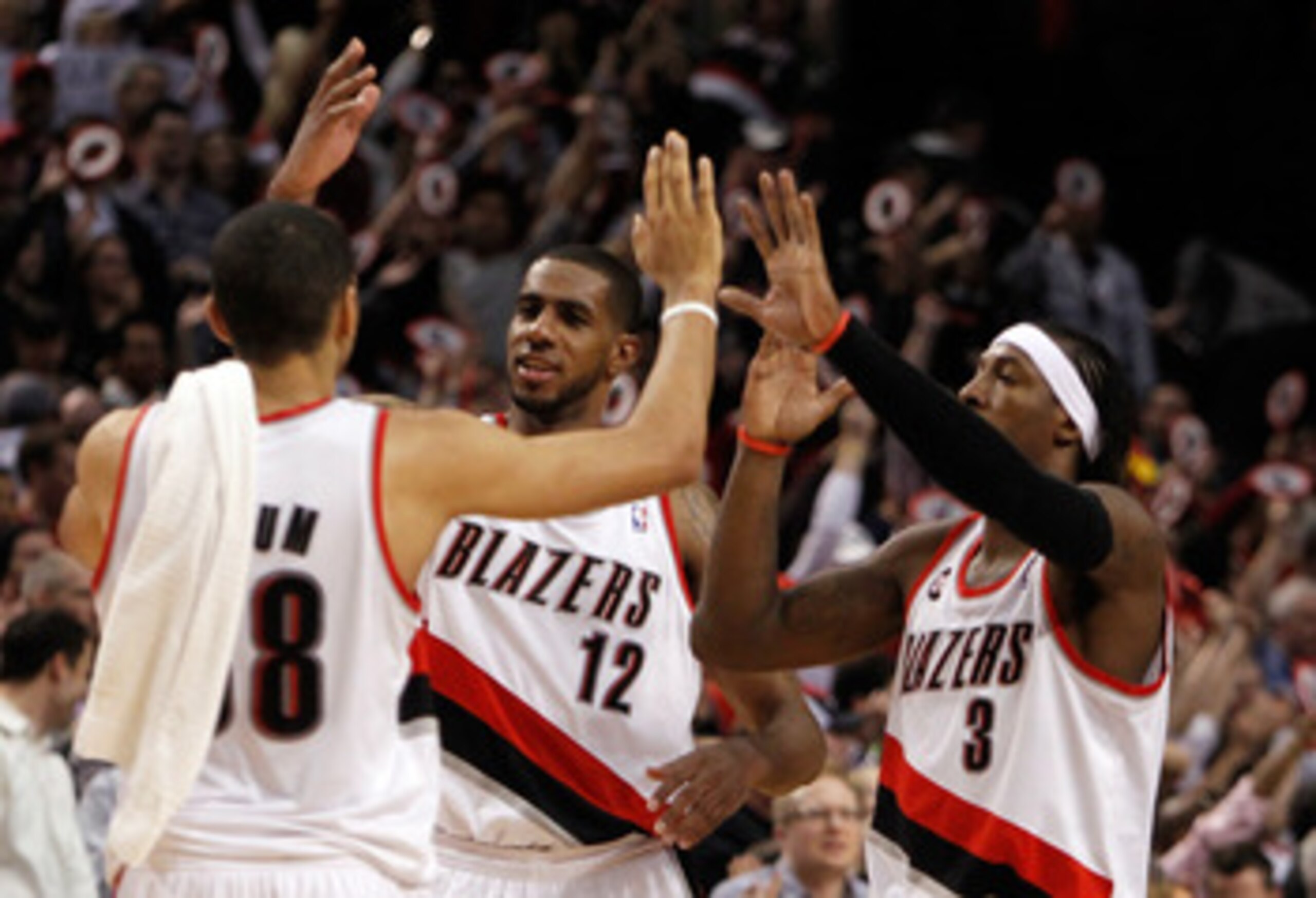 PORTLAND, OR - APRIL 21:  LaMarcus Aldridge #12, Gerald Wallace #3 and Nicolas Batum of the Portland Trail Blazers celebrates their 97-92 victory over the Dallas Mavericks in Game Three of the Western Conference Quarterfinals in the 2011 NBA Playoffs on A