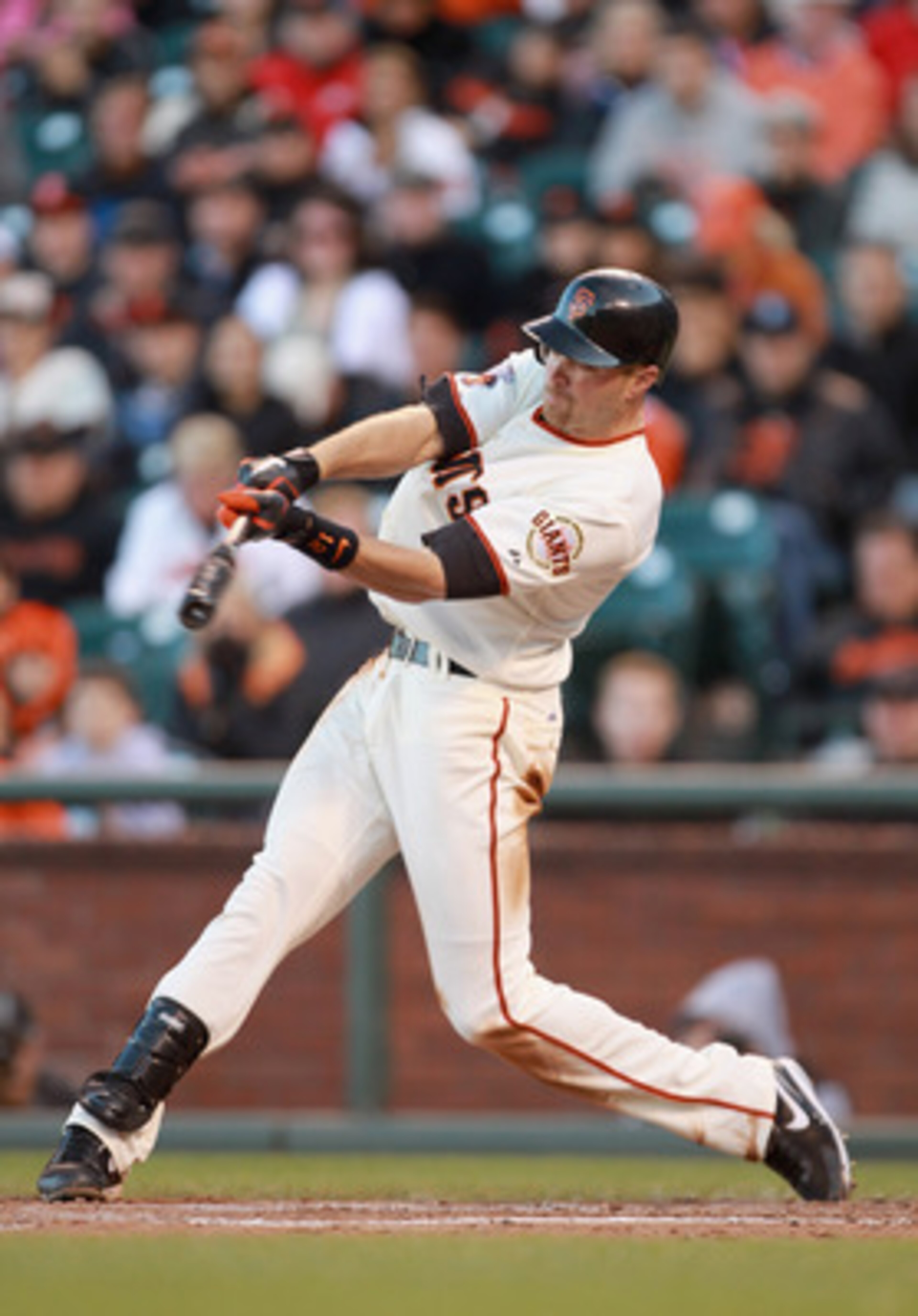 SAN FRANCISCO, CA - JUNE 12:  Nate Schierholtz #12 of the San Francisco Giants hits a sacrifice fly that scored Chris Stewart #37 of the San Francisco Giants for the go ahead run in the seventh inning against the Cincinnati Reds at AT&T Park on June 12, 2