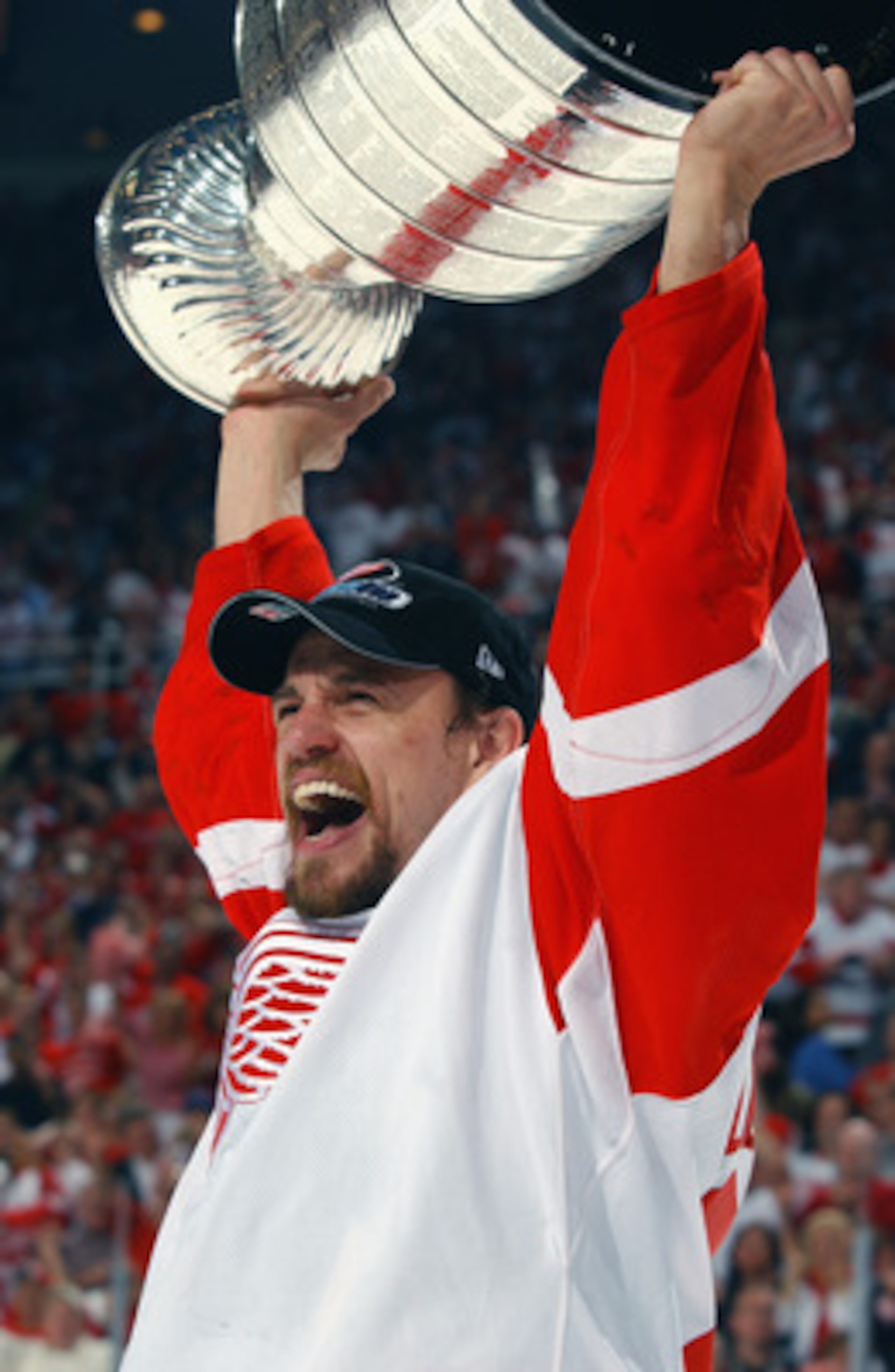 DETROIT, MI - JUNE 13:  Fredrik Olausson #27 of the Detroit Red Wings holds the Stanley Cup after defeating the Carolina Hurricanes 3-1 in game five of the NHL Stanley Cup Finals on June 13, 2002 at the Joe Louis Arena in Detroit, Michigan. (Photo by Dave