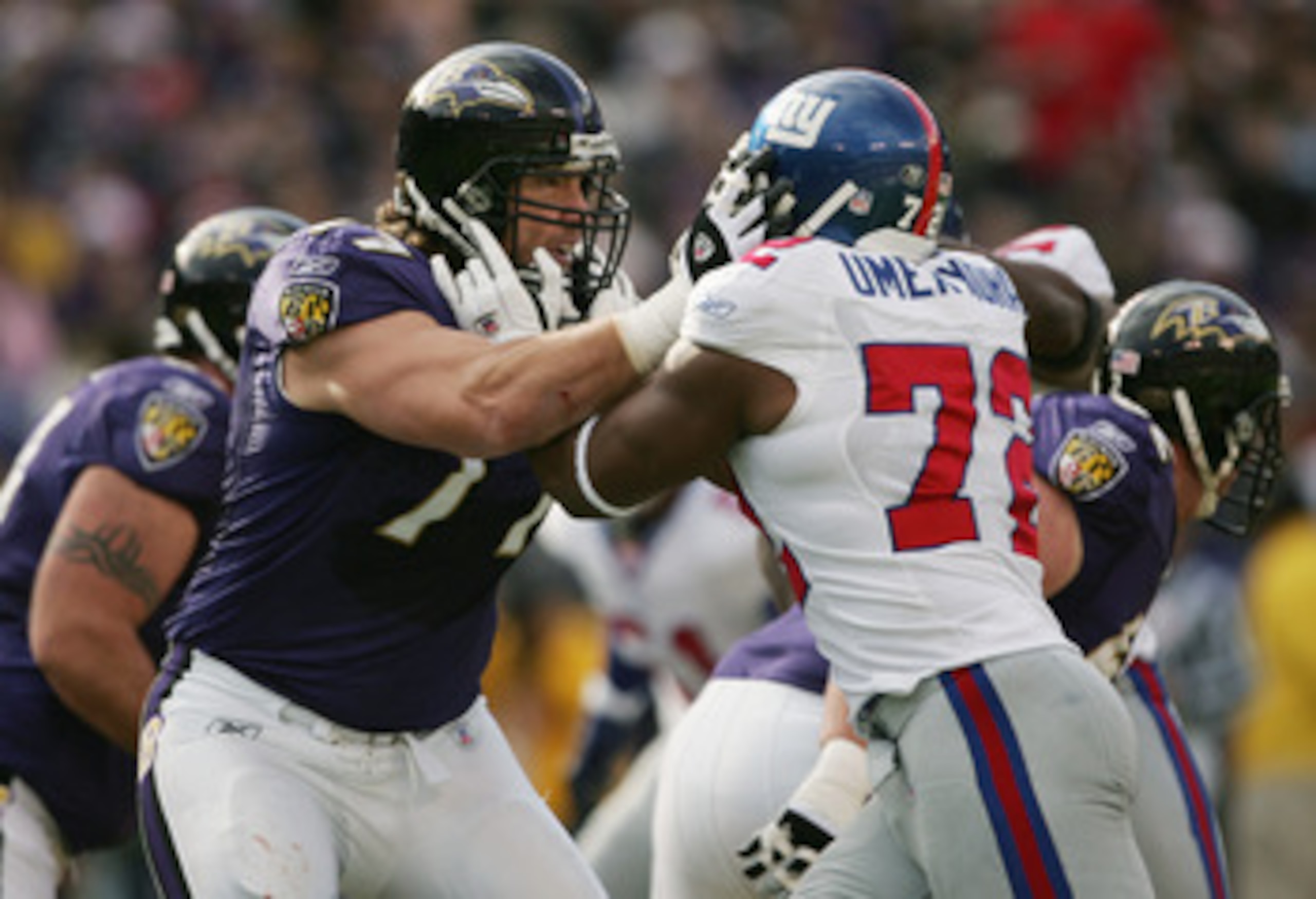 BALTIMORE - DECEMBER 12:  Defensive end Osi Umenyiora #72 of the New York Giants attempts to push his way past offensive tackle Ethan Brooks #77 of the Baltimore Ravens during the game at M&T Bank Stadium on December 12, 2004 in Baltimore, Maryland. The R