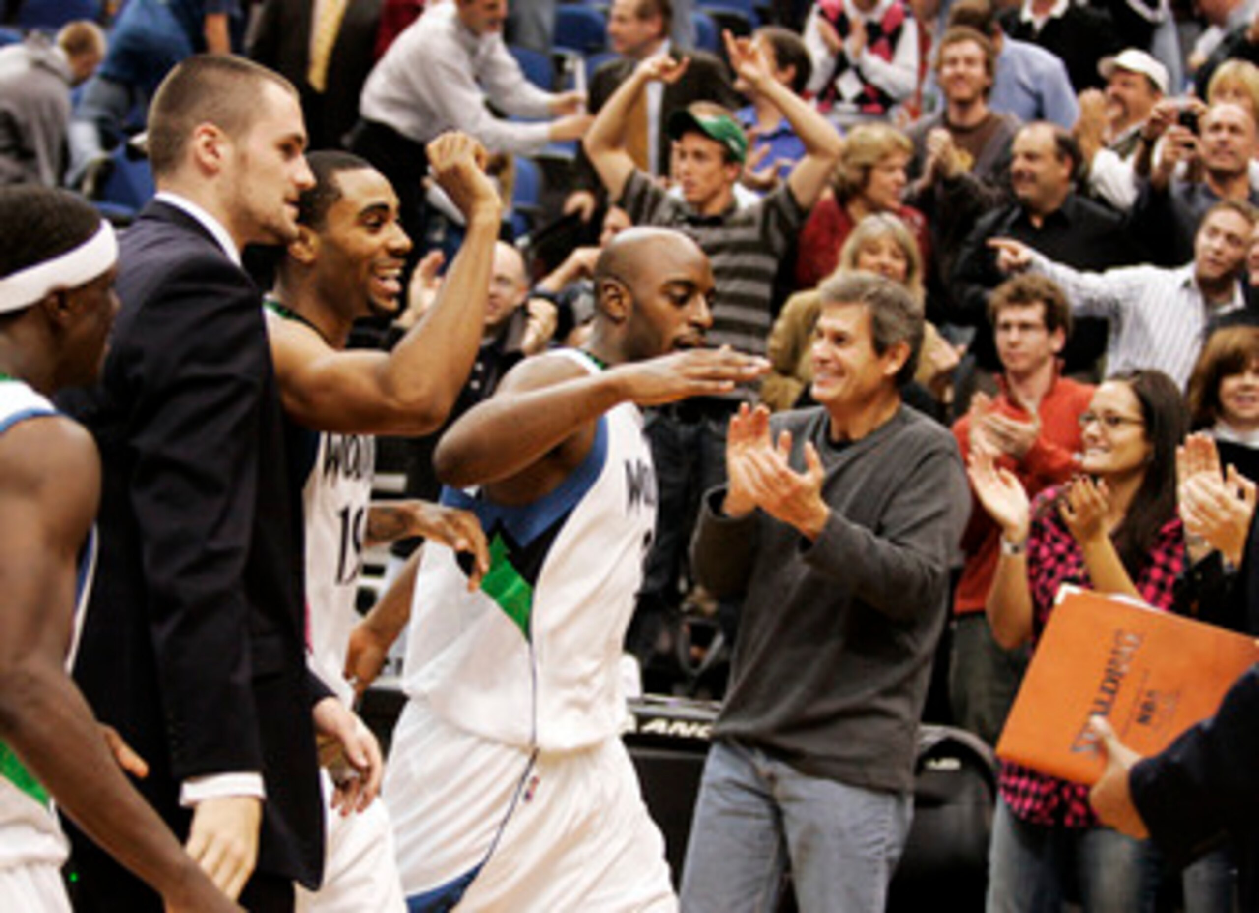 MINNEAPOLIS, MN - OCTOBER 28: Damien Wilkins #3 of the Minnesota Timberwolves celebrates with teammates and fans after scoring the game-winning shot at the buzzer against the New Jersey Nets at the Target Center on October 28, 2009 in Minneapolis, Minneso MINNEAPOLIS, MN - OCTOBER 28: Damien Wilkins #3 of the Minnesota Timberwolves celebrates with teammates and fans after scoring the game-winning shot at the buzzer against the New Jersey Nets at the Target Center on October 28, 2009 in Minneapolis, Minneso