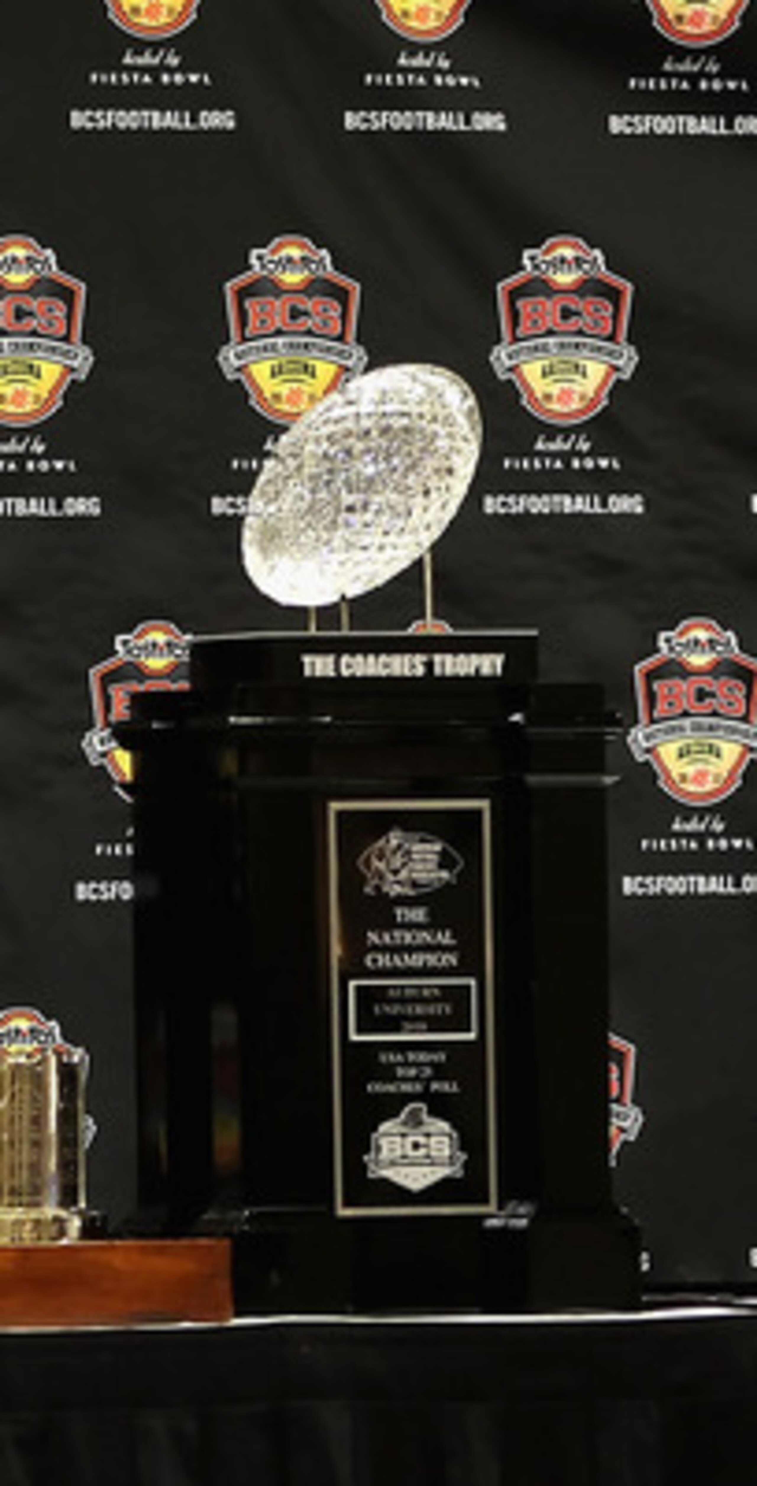 SCOTTSDALE, AZ - JANUARY 11:  Head coach Gene Chizik of the Auburn Tigers sits with the (L-R) Associated Press, Football Writers of America, MacArthur Bowl and the Coaches trophys during a press conference for the Tostitos BCS National Championship Game a