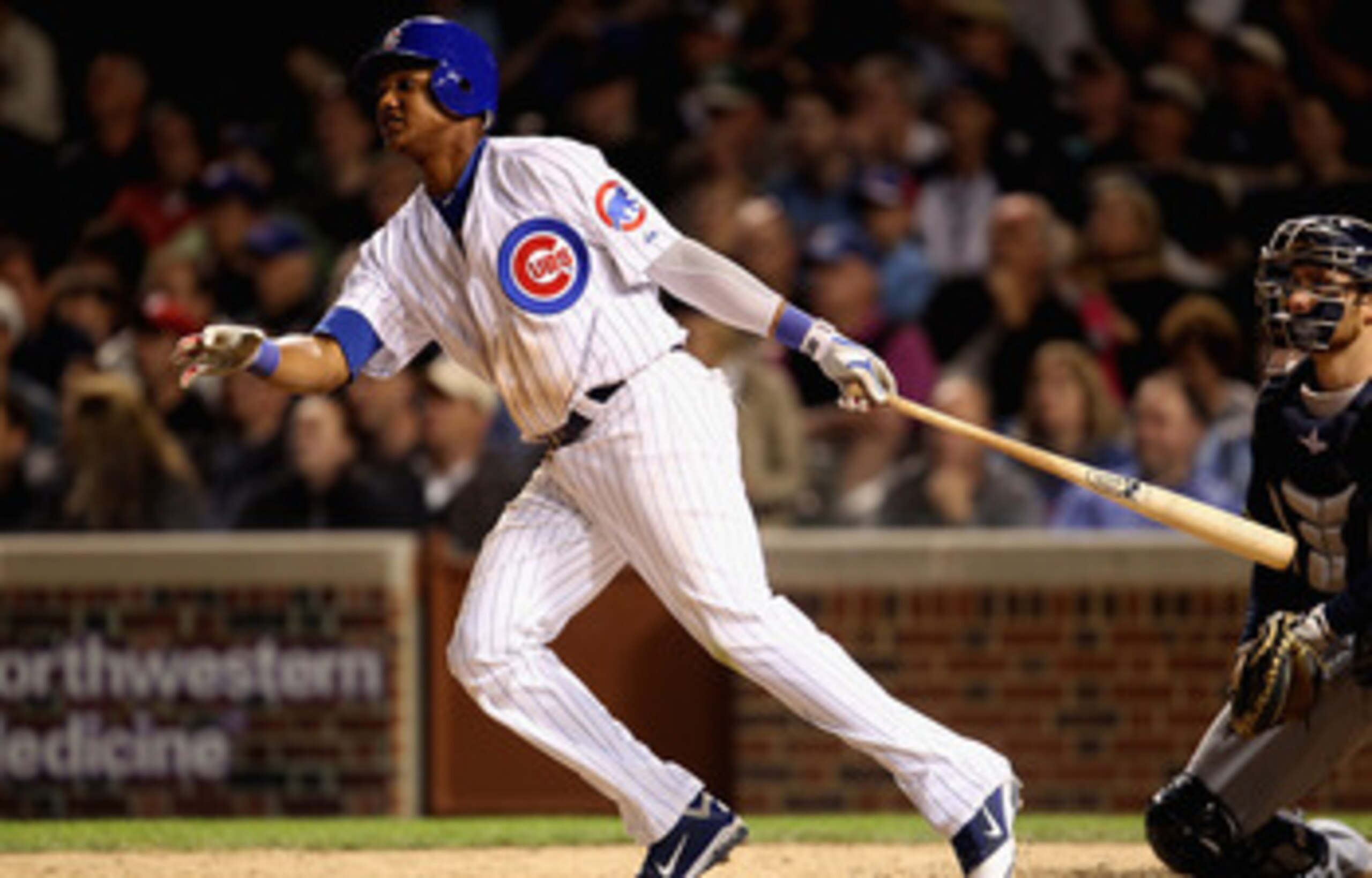 CHICAGO, IL - JUNE 14:  Starlin Castro #13 of the Chicago Cubs hits a double against the Milwaukee Brewers at Wrigley Field on June 14, 2011 in Chicago, Illinois. The Cubs defeated the Brewers 5-4 in 10 innings.  (Photo by Jonathan Daniel/Getty Images)