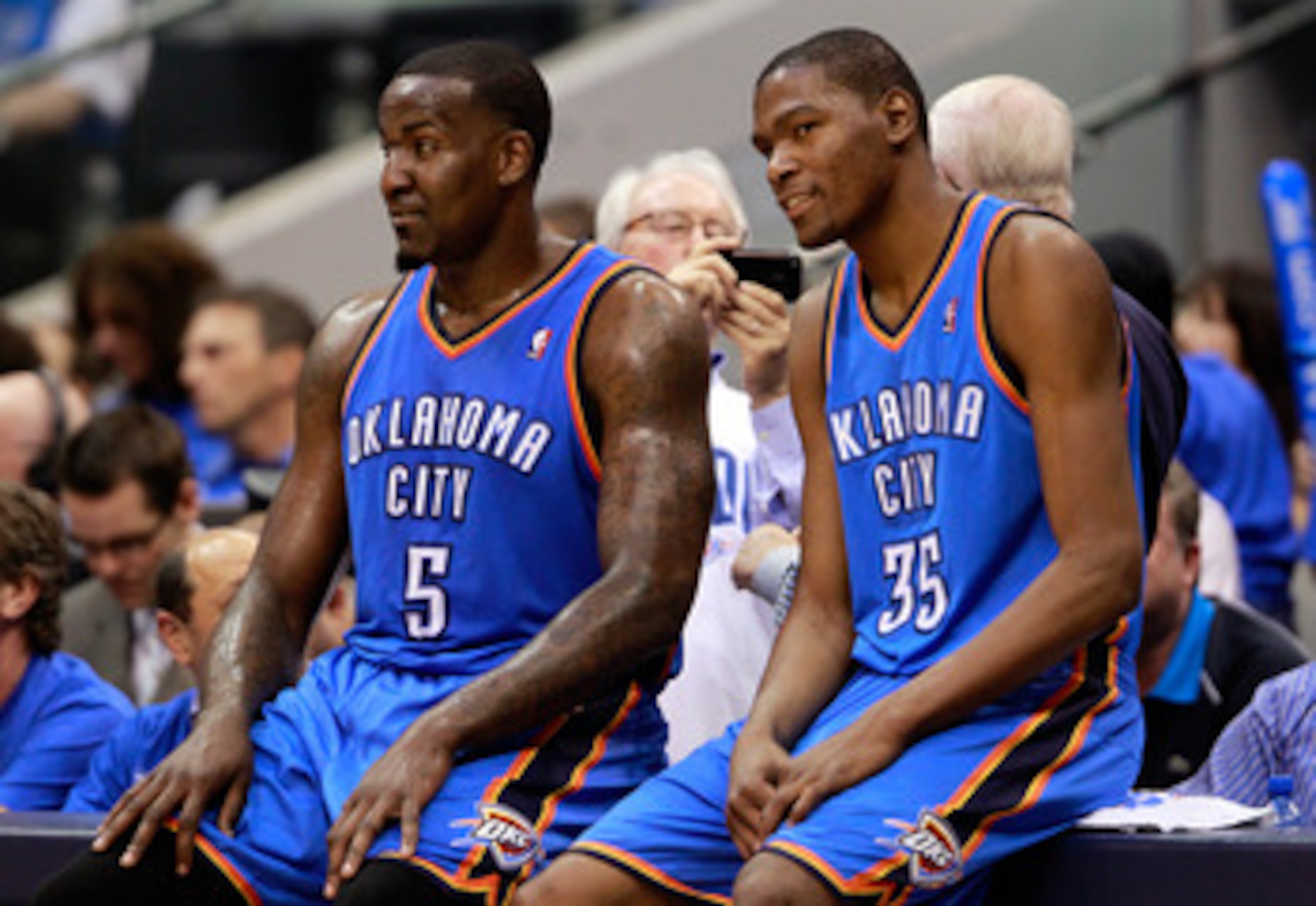 DALLAS, TX - MAY 19:  Kendrick Perkins #5 and Kevin Durant #35 of the Oklahoma City Thunder wait to enter the game in the third quarter while taking on the Dallas Mavericks in Game Two of the Western Conference Finals during the 2011 NBA Playoffs at Ameri