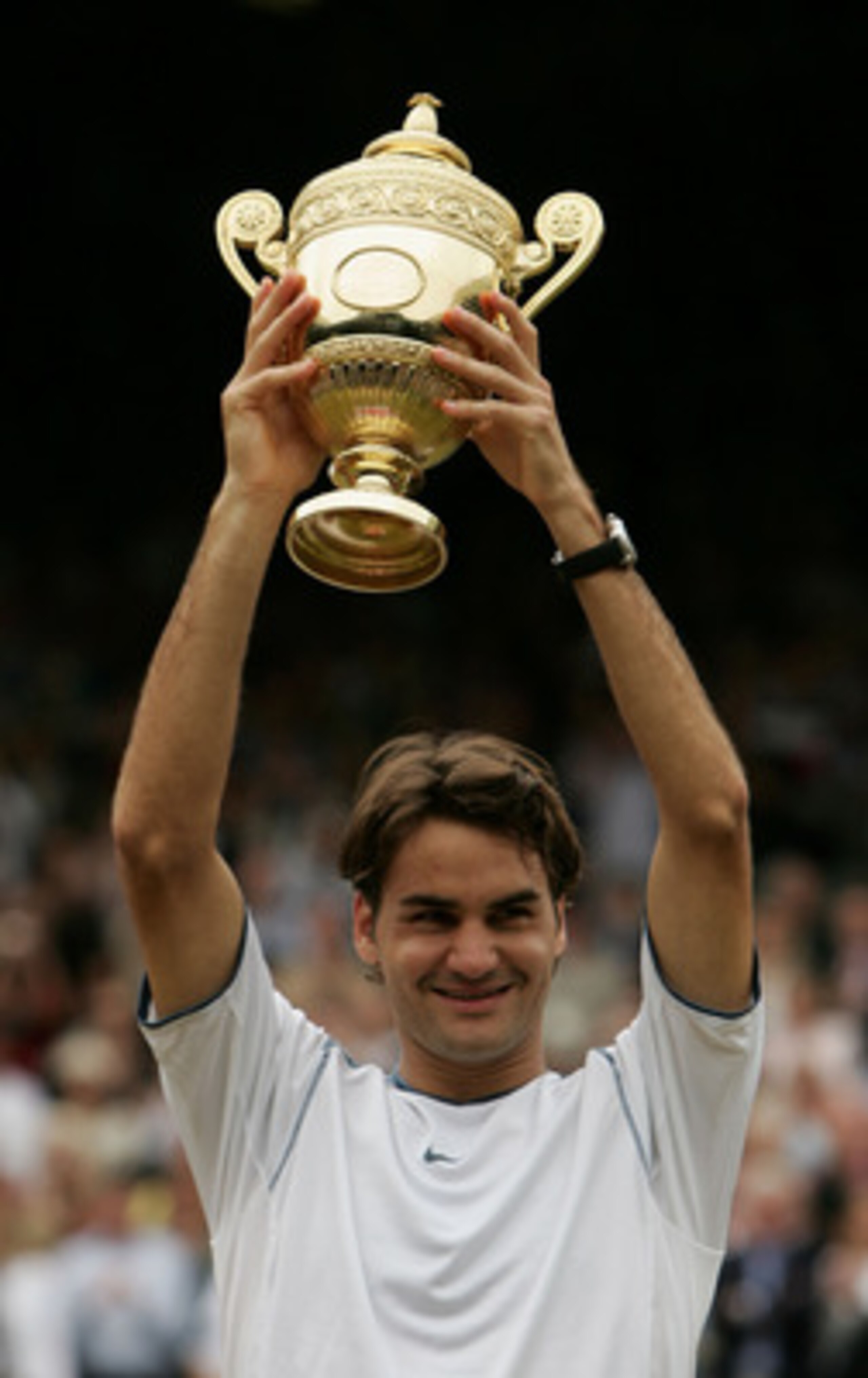 LONDON - JULY 03:  Roger Federer of Switzerland holds the trophy high after winning in straight sets against Andy Roddick of the USA in the Mens Singles final during the thirteenth day of the Wimbledon Lawn Tennis Championship on July 3, 2005 at the All E