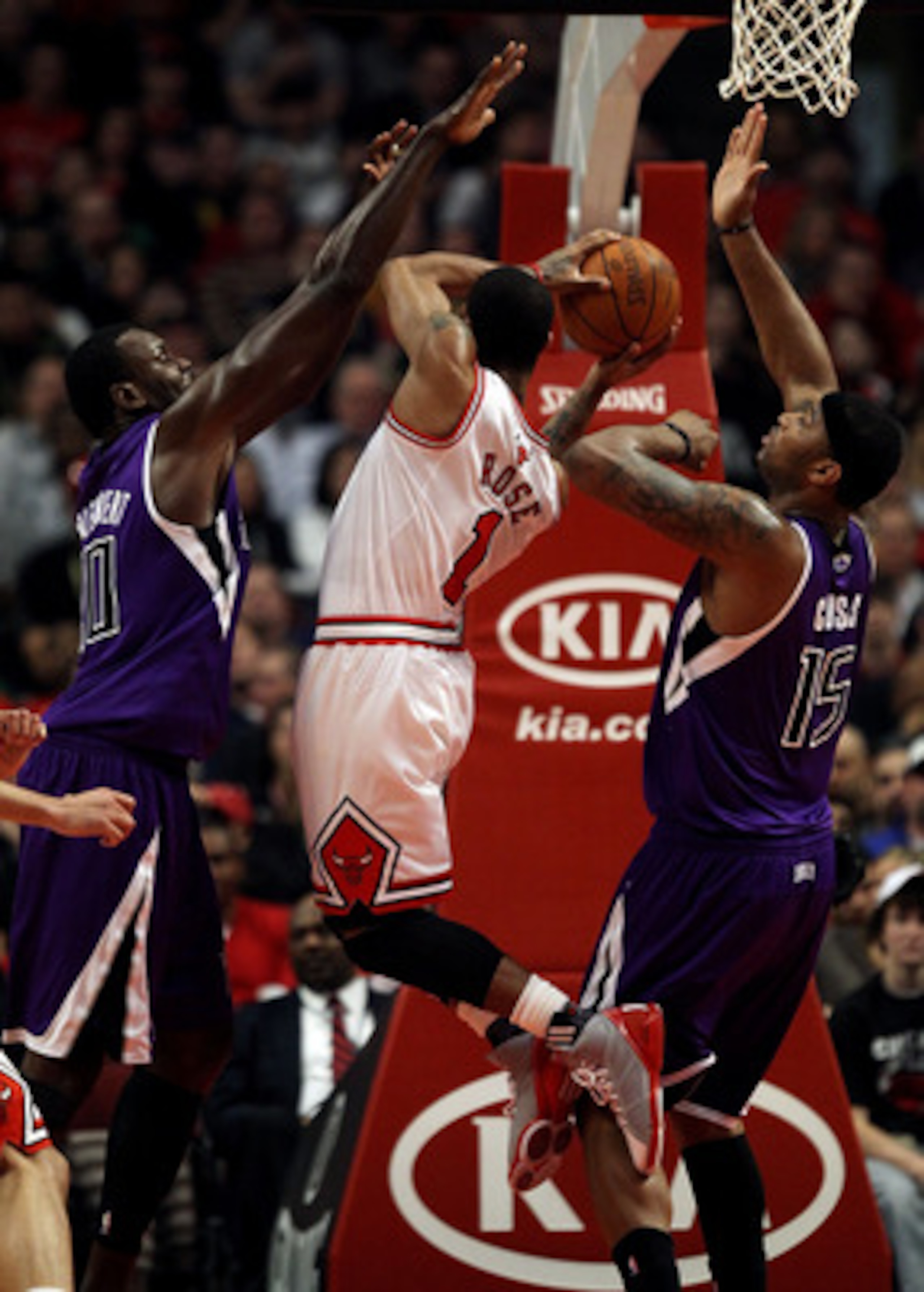 CHICAGO, IL - MARCH 21: Derrick Rose #1 of the Chicago Bulls puts up a shot between Samuel Dalembert #10 (L) and DeMarcus Cousins #15 of the Sacramento Kings at the United Center on March 21, 2011 in Chicago, Illinois. NOTE TO USER: User expressly acknowl