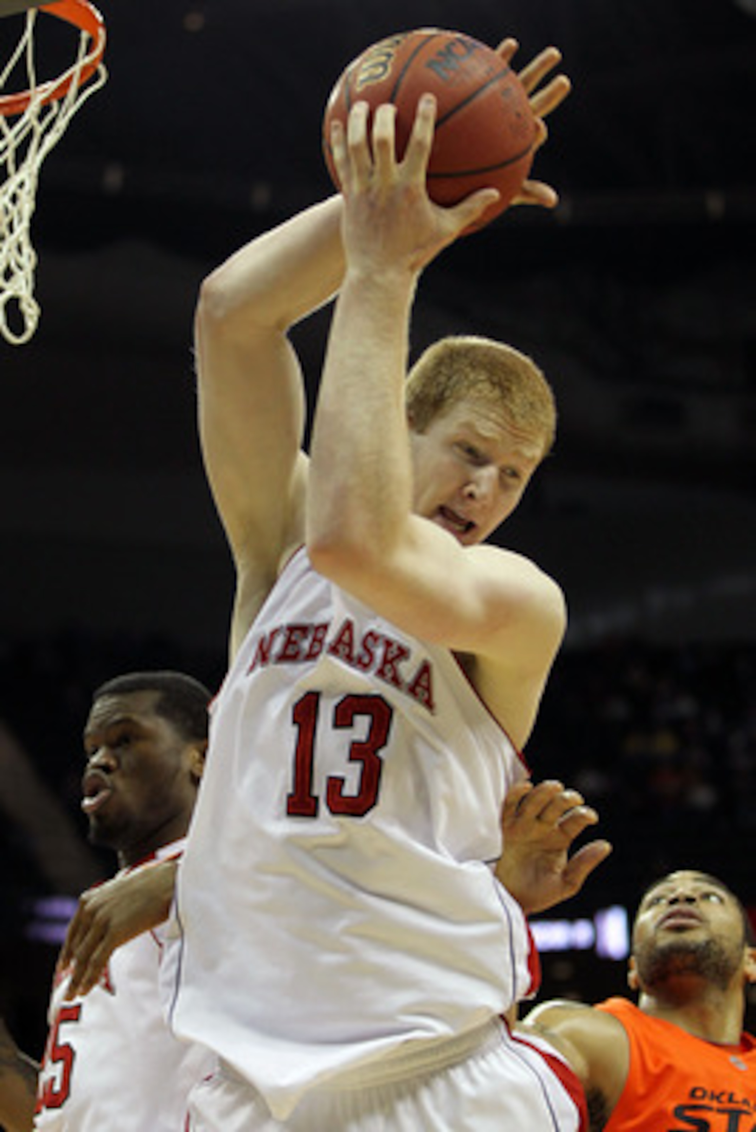 KANSAS CITY, MO - MARCH 09:  Brandon Ubel #13 of the Nebraska Cornhuskers grabs a rebound against the Oklahoma State Cowboys during their first round game in the 2011 Phillips 66 Big 12 Men's Basketball Tournament at Sprint Center on March 9, 2011 in Kans