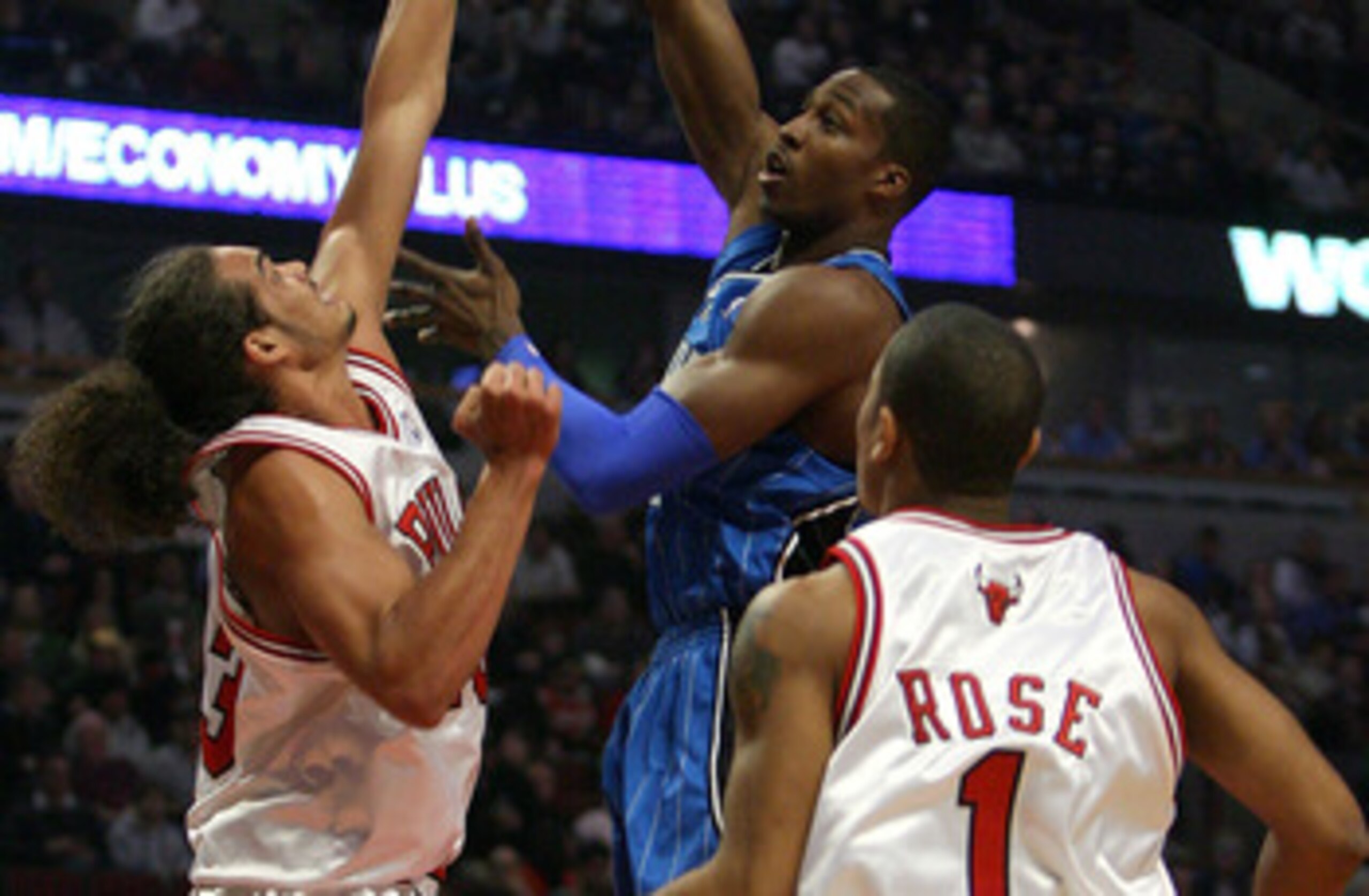 CHICAGO - FEBRUARY 24:  Dwight Howard #12 of the Orlando Magic attempts a shot aganst Joakim Noah #13 and Derrick Rose #1 of the Chicago Bulls at the United Center on Feberuary 24, 2009 in Chicago, Illinois.  NOTE TO USER: User expressly acknowledges and