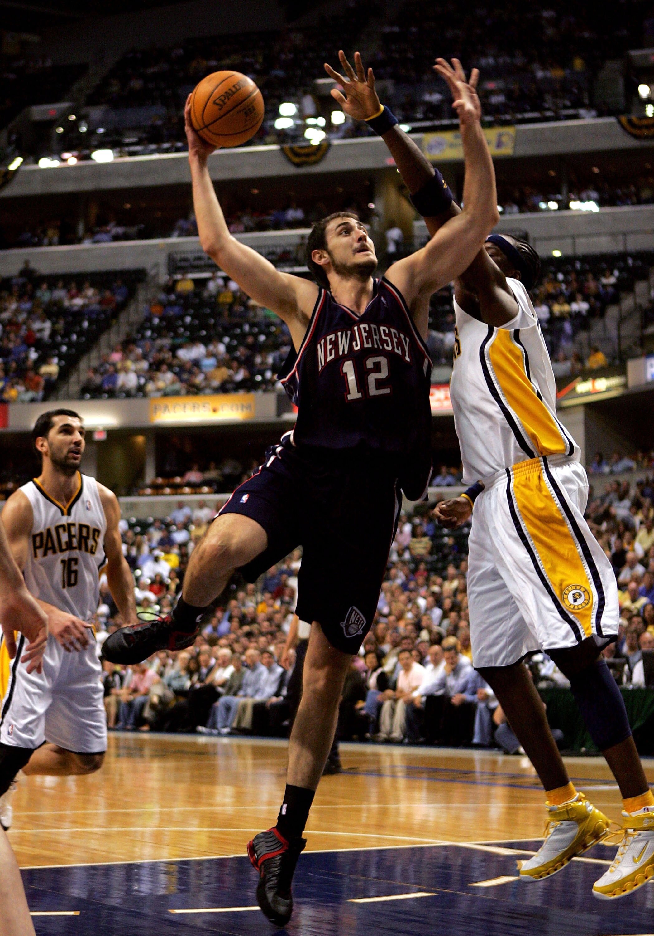 INDIANAPOLIS - APRIL 27:  Nenad Krstic #12 of the New Jersey Nets goes up for a shot against Jermaine O'Neal #7 of the Indiana Pacers during game three of the first round of the NBA playoffs April 27, 2006 at Conseco Fieldhouse in Indianapolis, Inidiana.