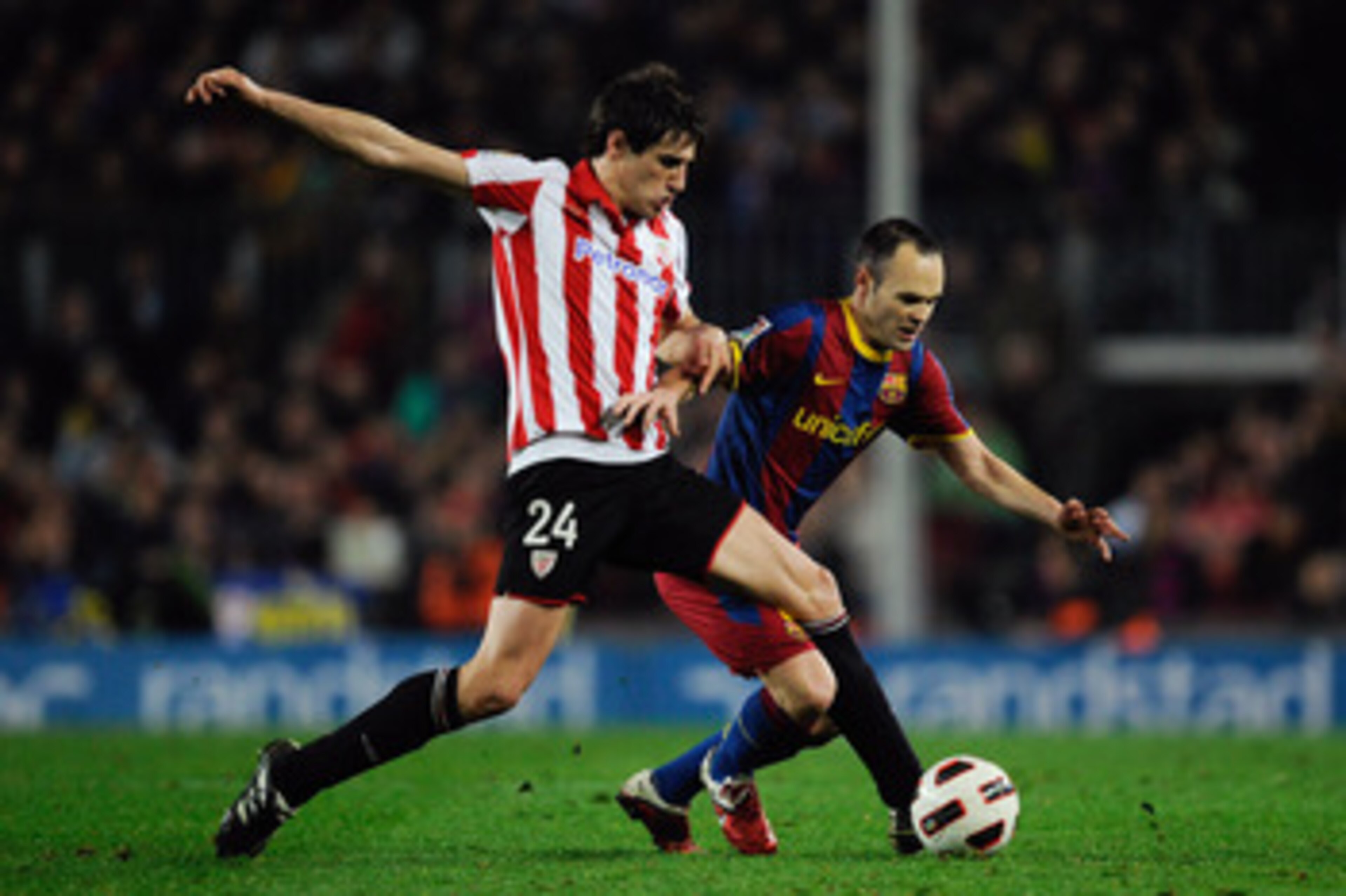 BARCELONA, SPAIN - FEBRUARY 20:  Andres Inieta of FC Barcelona (R) fights for the ball against Javi Martinez of Athletic Bilbao during the La Liga match between FC Barcelona and Athletic Bilbao at Camp Nou on February 20, 2011 in Barcelona, Spain. Barcelo