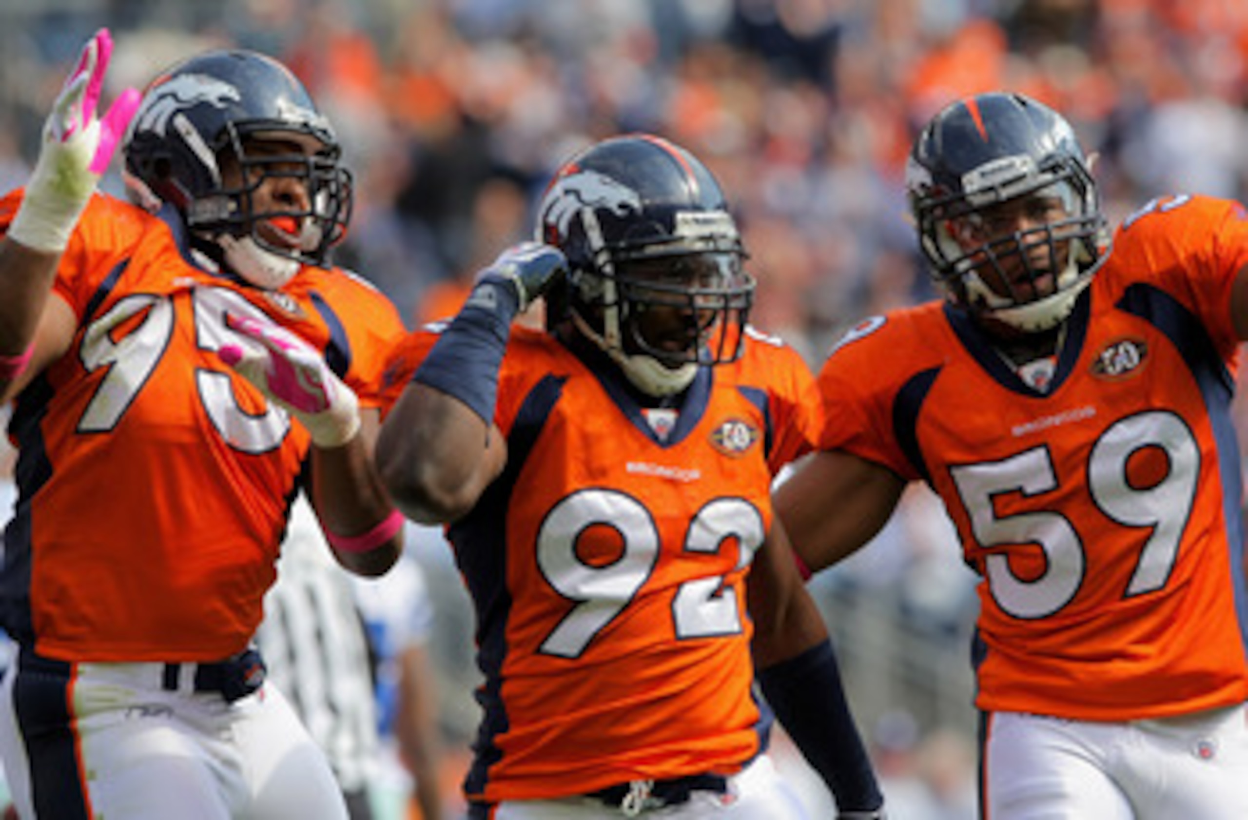 DENVER - OCTOBER 04: Elivs Dumervil #92 of the Denver Broncos celebrates his sack of quarterback Tony Romo #9 of the Dallas Cowboys with teammates Darrell Reid #95 and Wesley Woodyard #59 during NFL action at Invesco Field at Mile High on October 4, 2009 DENVER - OCTOBER 04: Elivs Dumervil #92 of the Denver Broncos celebrates his sack of quarterback Tony Romo #9 of the Dallas Cowboys with teammates Darrell Reid #95 and Wesley Woodyard #59 during NFL action at Invesco Field at Mile High on October 4, 2009