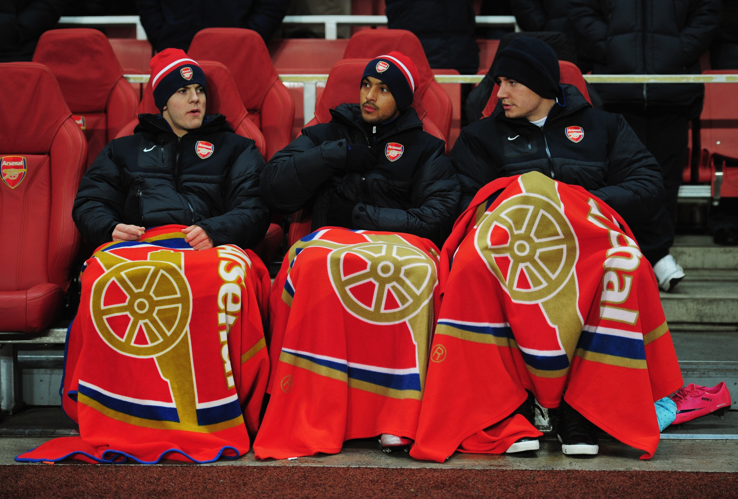 LONDON, ENGLAND - DECEMBER 08: Substitutes Jack Wilshere, Theo Walcott and Nicklas Bendtner of Arsenal attempt to keep warm as they sit on the bench prior to the UEFA Champions League Group H match between Arsenal and FK Partizan Belgrade at the Emirates LONDON, ENGLAND - DECEMBER 08: Substitutes Jack Wilshere, Theo Walcott and Nicklas Bendtner of Arsenal attempt to keep warm as they sit on the bench prior to the UEFA Champions League Group H match between Arsenal and FK Partizan Belgrade at the Emirates