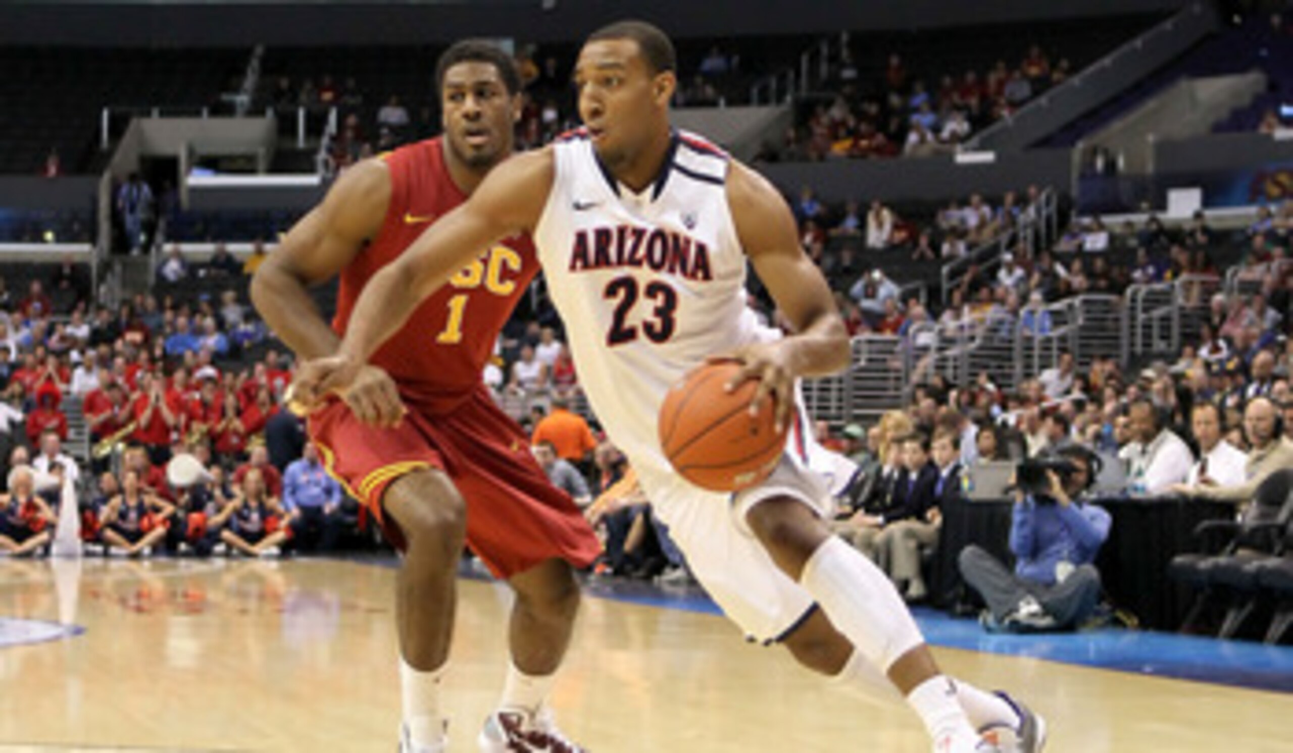LOS ANGELES, CA - MARCH 11:  Derrick Williams #23 of the Arizona Wildcats drives on Alex Stepheson #1 of the USC Trojans in the first half in the semifinals of the 2011 Pacific Life Pac-10 Men's Basketball Tournament at Staples Center on March 11, 2011 in