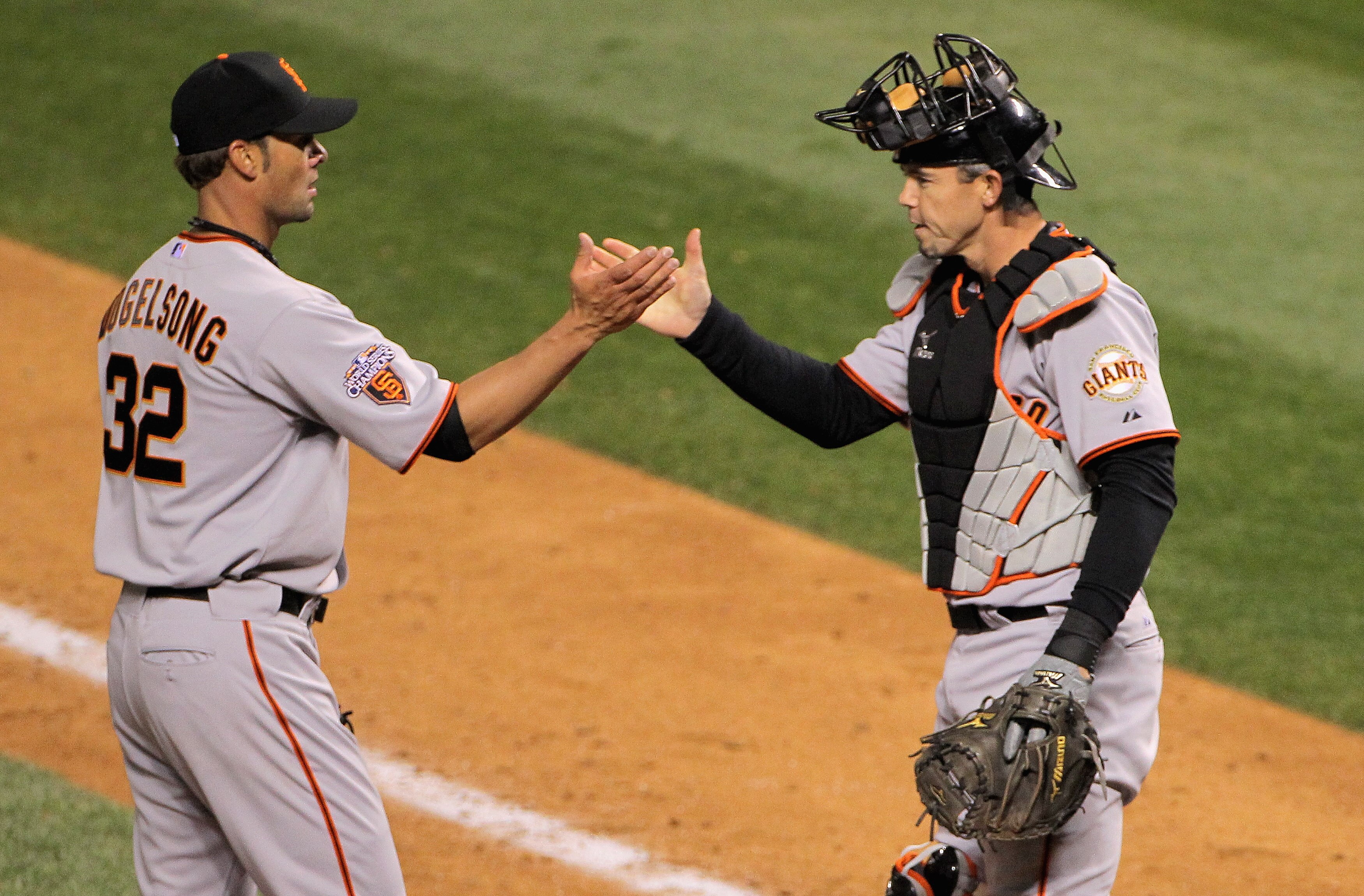 DENVER, CO - APRIL 18:  Pitcher Ryan Vogelsong #32 of the San Francisco Giants and catcher Eli Whiteside #22 of the San Francisco Giants celebrate their 8-1 victory over the Colorado Rockies at Coors Field on April 18, 2011 in Denver, Colorado.  (Photo by