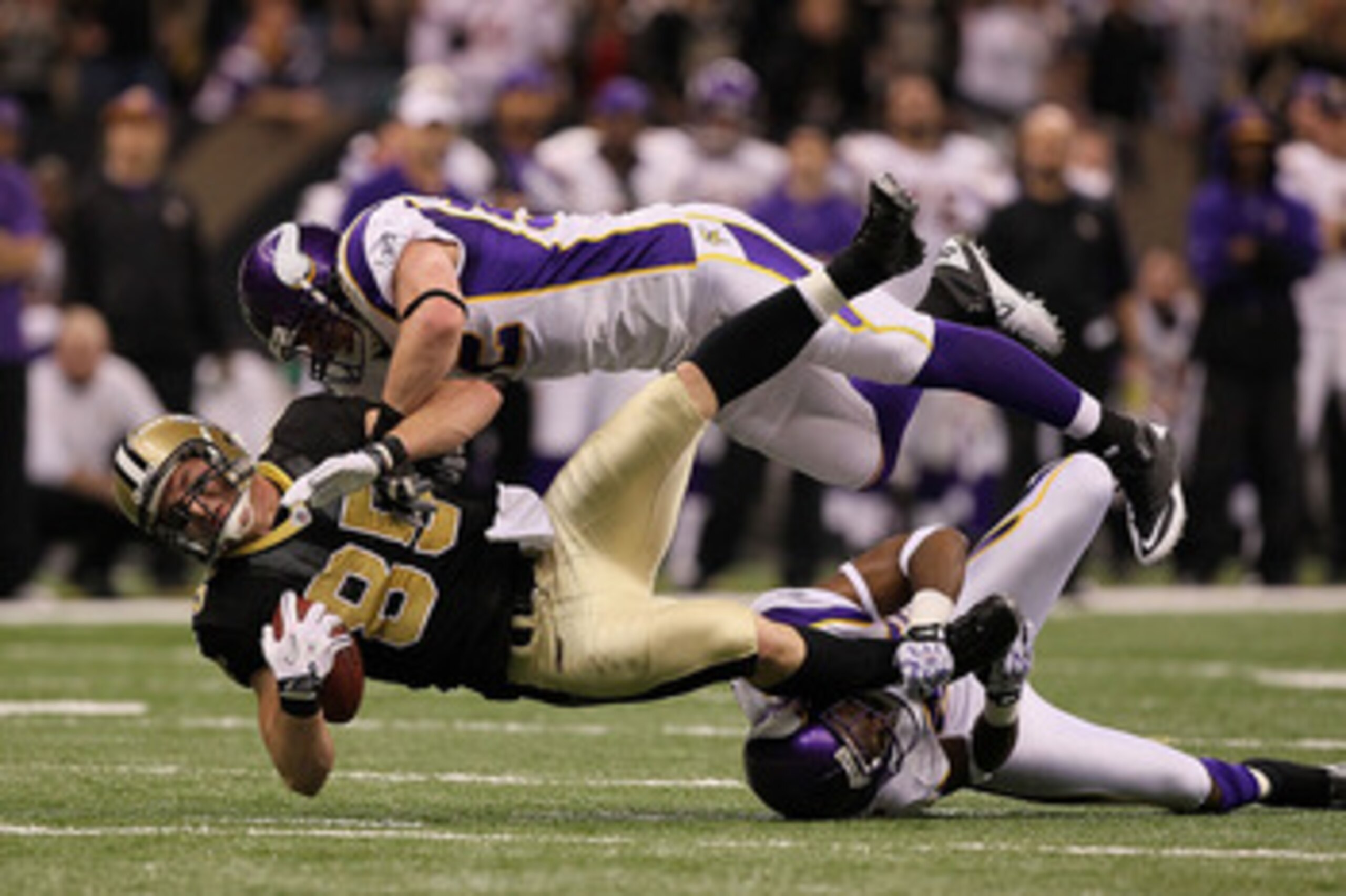 NEW ORLEANS - JANUARY 24:  Jeremy Shockey #88 of the New Orleans Saints gets tackled by Chad Greenway #52 and Antoine Winfield #26 of the Minnesota Vikings after catching a pass for a first down during the NFC Championship Game at the Louisana Superdome o