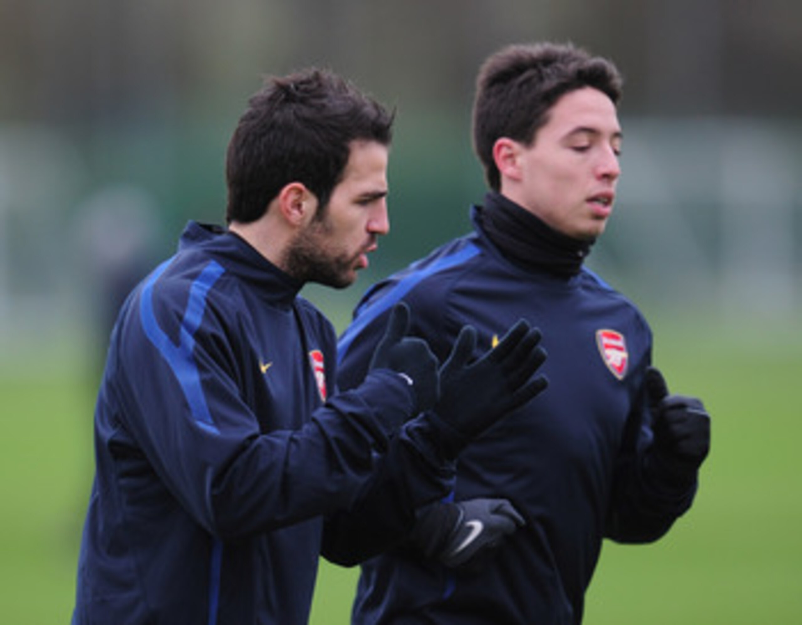 ST ALBANS, ENGLAND - FEBRUARY 15:  Cesc Fabregas and Samir Nasri of Arsenal warm-up during training at London Colney on February 15, 2011 in St Albans, England.  (Photo by Shaun Botterill/Getty Images)
