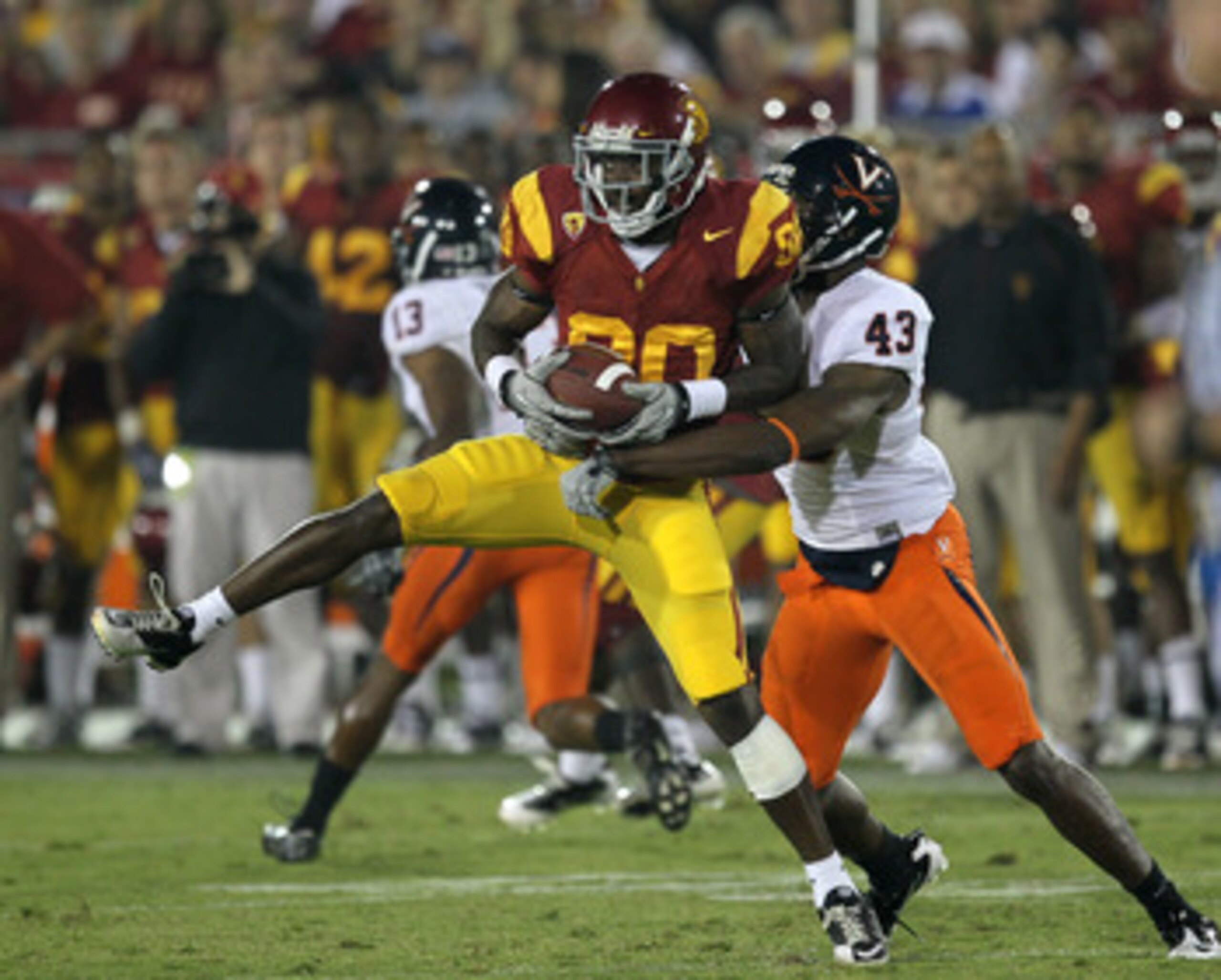 LOS ANGELES, CA - SEPTEMBER 11:  Wide receiver Brandon Carswell #80 of the USC Trojans makes a catch in front of cornerback Mike Parker #43 of the Virginia Cavaliers at Los Angeles Memorial Coliseum on September 11, 2010 in Los Angeles, California. USC wo