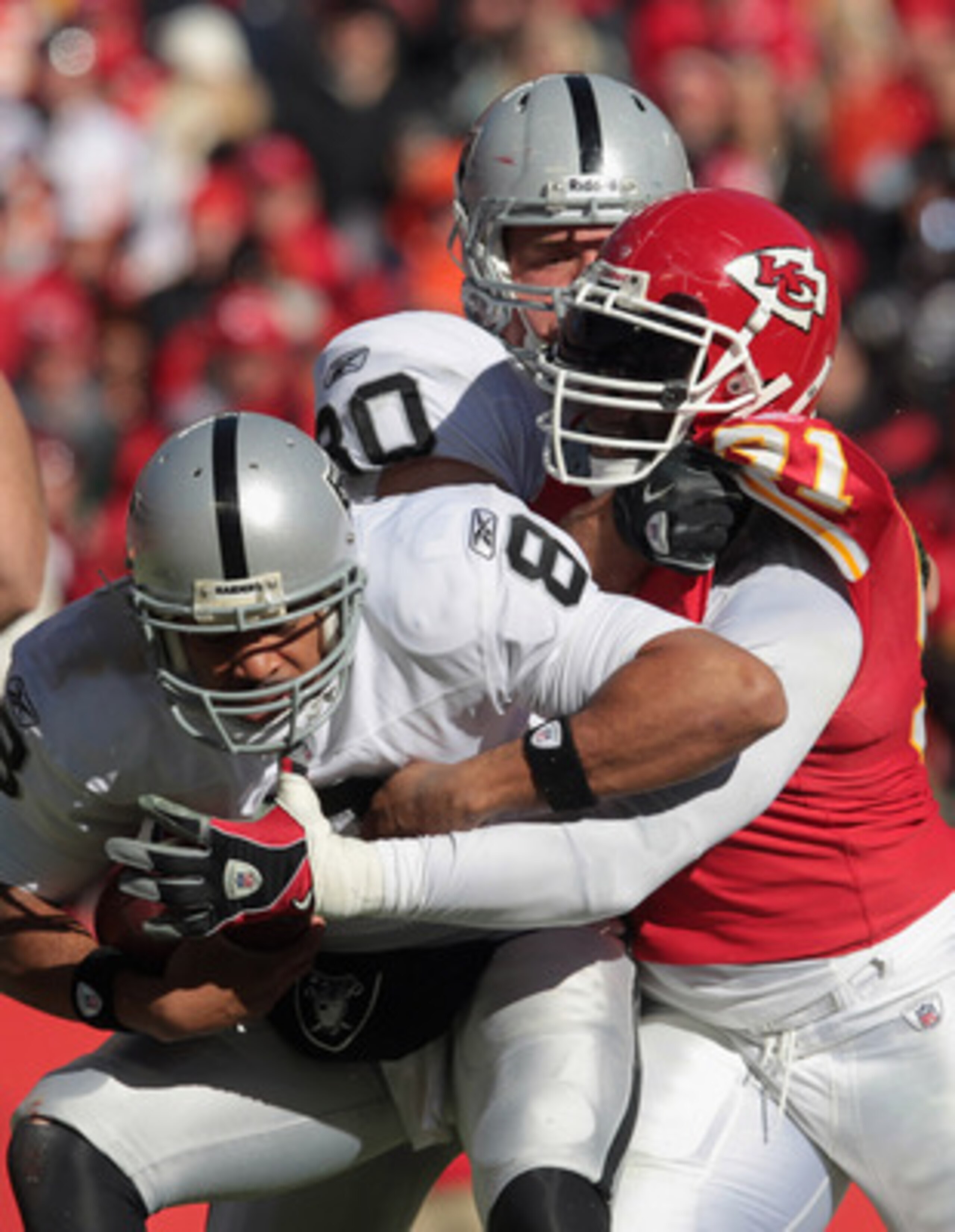 KANSAS CITY, MO - JANUARY 02:  Quarterback Jason Campbell #8 of the Oakland Raiders is sacked by Tamba Hali #91 of the Kansas City Chiefs during the game on January 2, 2011 at Arrowhead Stadium in Kansas City, Missouri.  (Photo by Jamie Squire/Getty Image