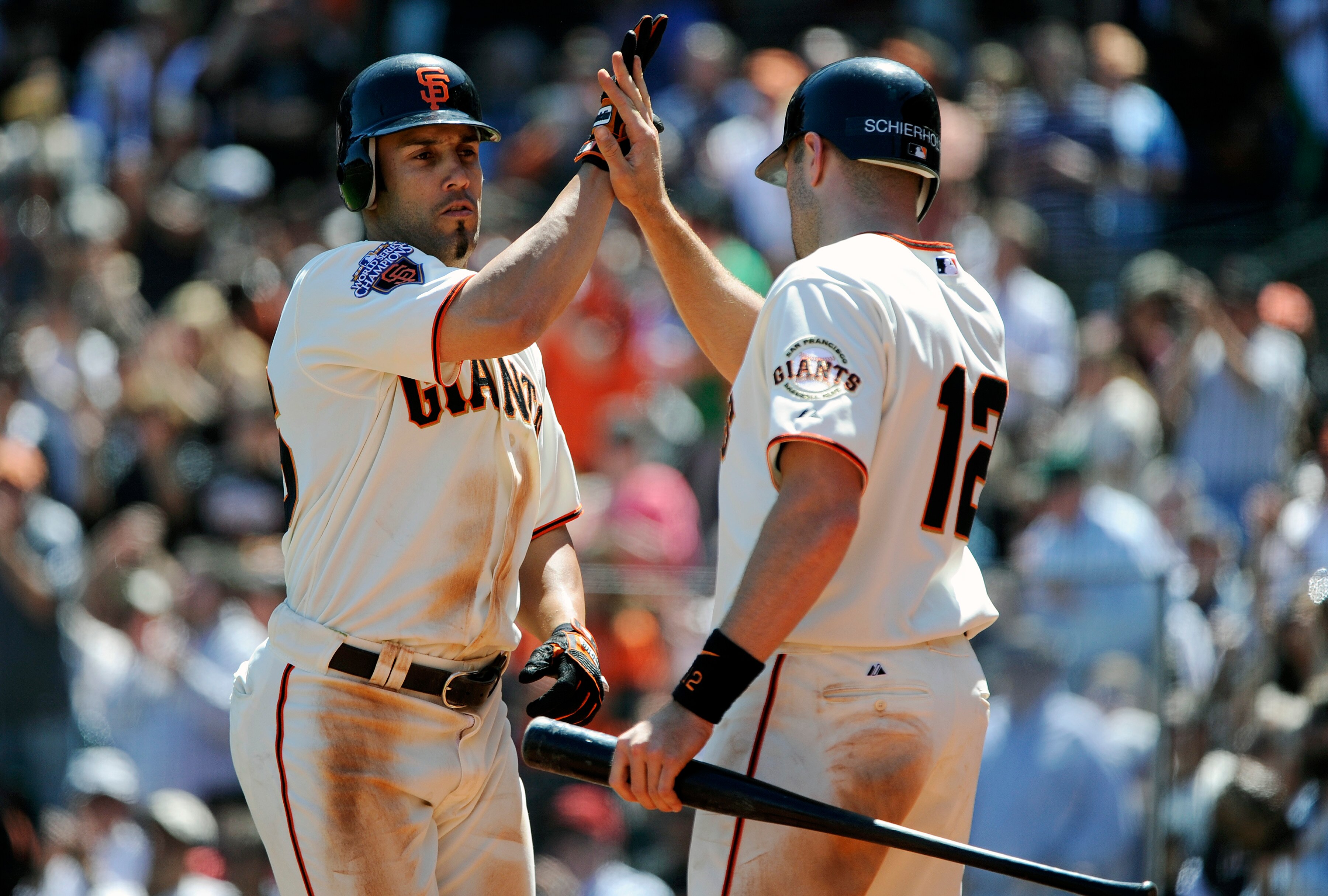 SAN FRANCISCO, CA - MAY 12:  Andres Torres #56 of the San Francisco Giants after scoring a run in the bottom of the seventh inning against the Arizona Diamondbacks gives teammate Nate Schierholtz #12 a high-five during a MLB baseball game at AT&T Park May