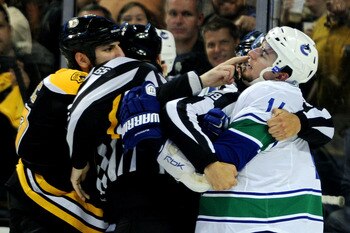 BOSTON, MA - JUNE 06:  Milan Lucic #17 of the Boston Bruins taunts Alex Burrows #14 of the Vancouver Canucks during Game Three of the 2011 NHL Stanley Cup Final at TD Garden on June 6, 2011 in Boston, Massachusetts.  (Photo by Harry How/Getty Images)