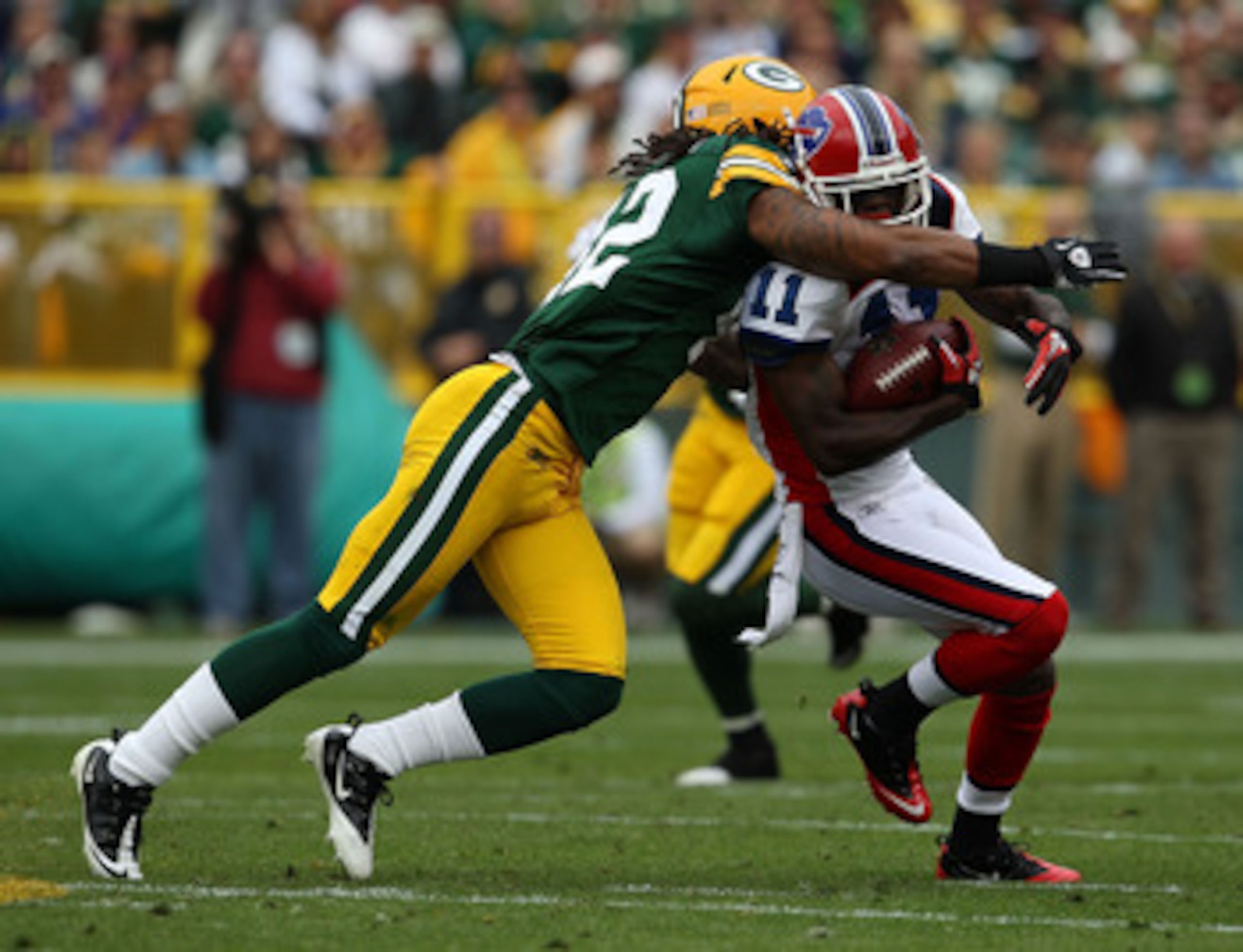 GREEN BAY, WI - SEPTEMBER 19: Roscoe Parrish #11 of the Buffalo Bills is hit by Morgan Burnett #42 of the Green Bay Packers after catching a pass at Lambeau Field on September 19, 2010 in Green Bay, Wisconsin. The Packers defeated the Bills 34-7.  (Photo 