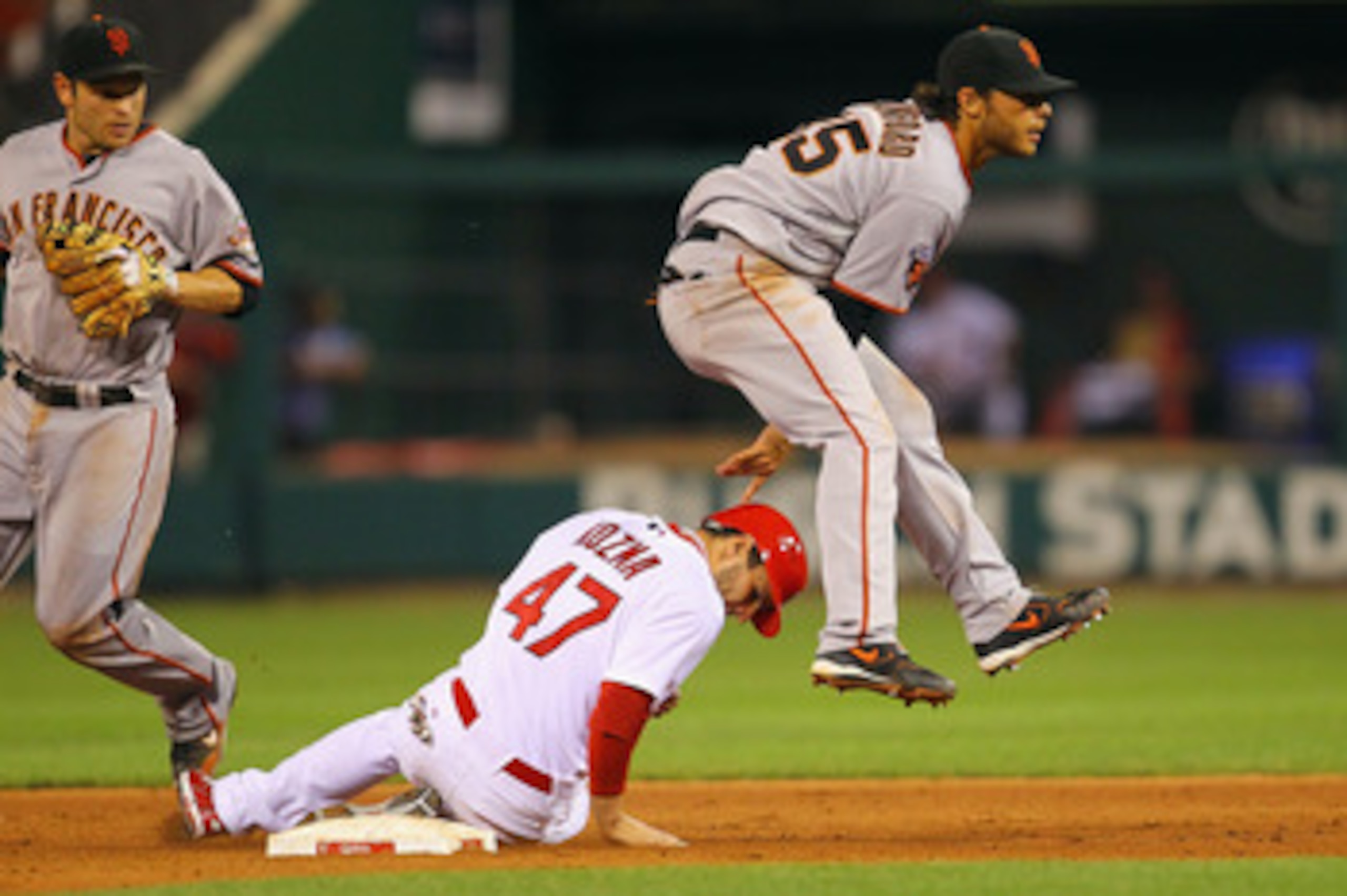 ST. LOUIS, MO - JUNE 1: Brandon Crawford #35 of the San Francisco Giants turns a double play over Pete Kozma #47 of the St. Louis Cardinals at Busch Stadium on June 1, 2011 in St. Louis, Missouri.  (Photo by Dilip Vishwanat/Getty Images)